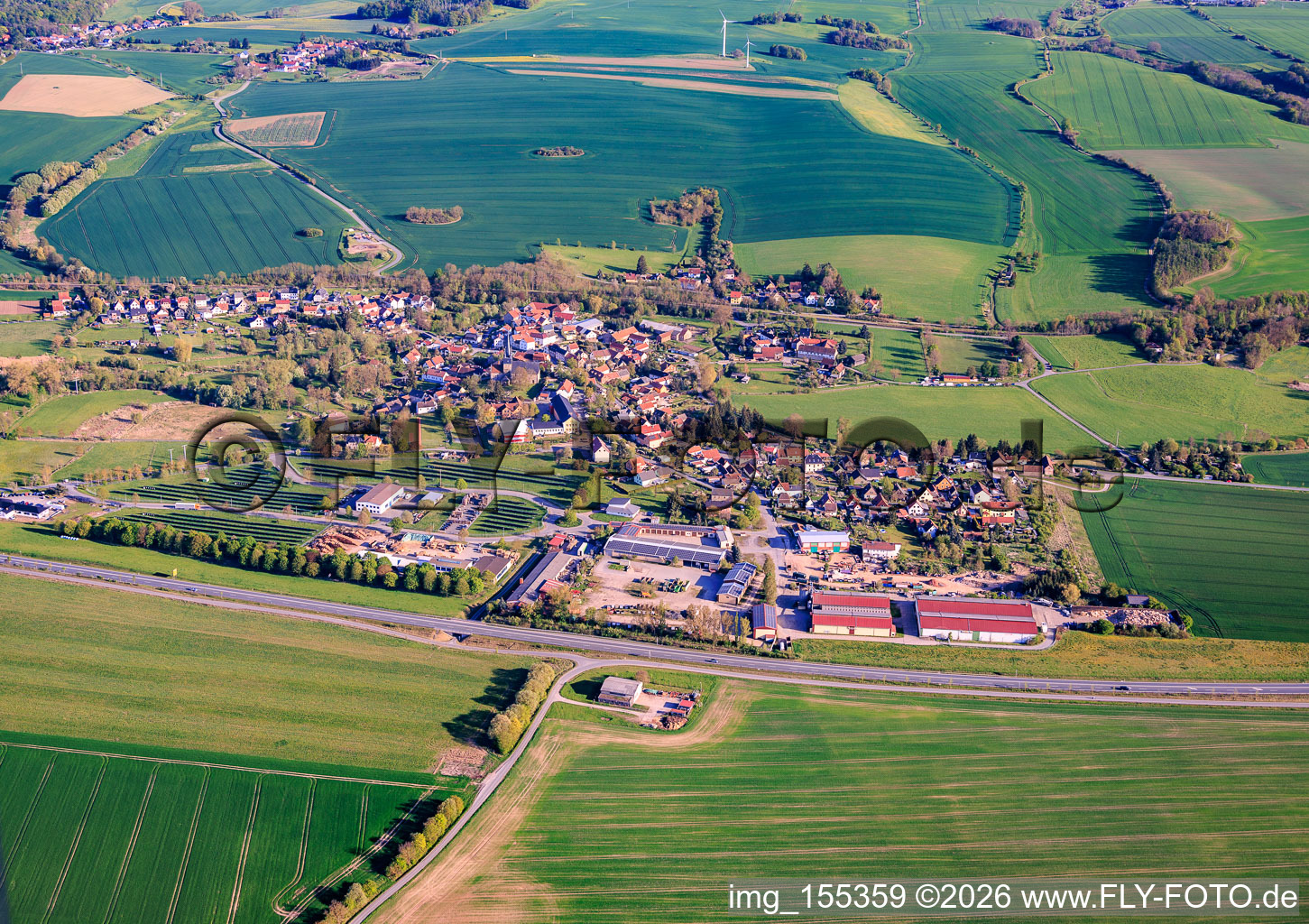 Village view from the north beyond the B281 with REMONDIS Mitteldeutschland GmbH branch Neunhofen and Wood Manufacturing Group Inc. pallet construction in the district Neunhofen in Neustadt an der Orla in the state Thuringia, Germany