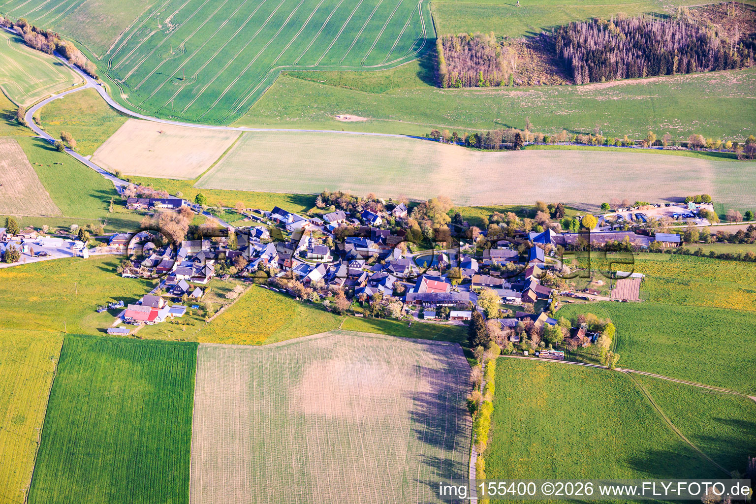 Village view from the north with round village pond and St. Mauritius Church. in the district Burglemnitz in Remptendorf in the state Thuringia, Germany