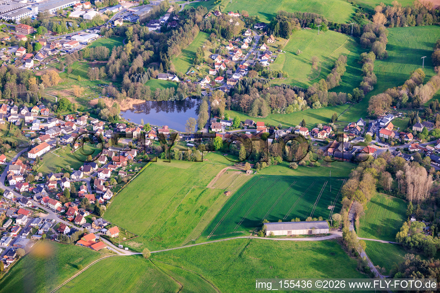Village view with heart-shaped mill pond from the north in the district Schierschnitz in Föritztal in the state Thuringia, Germany