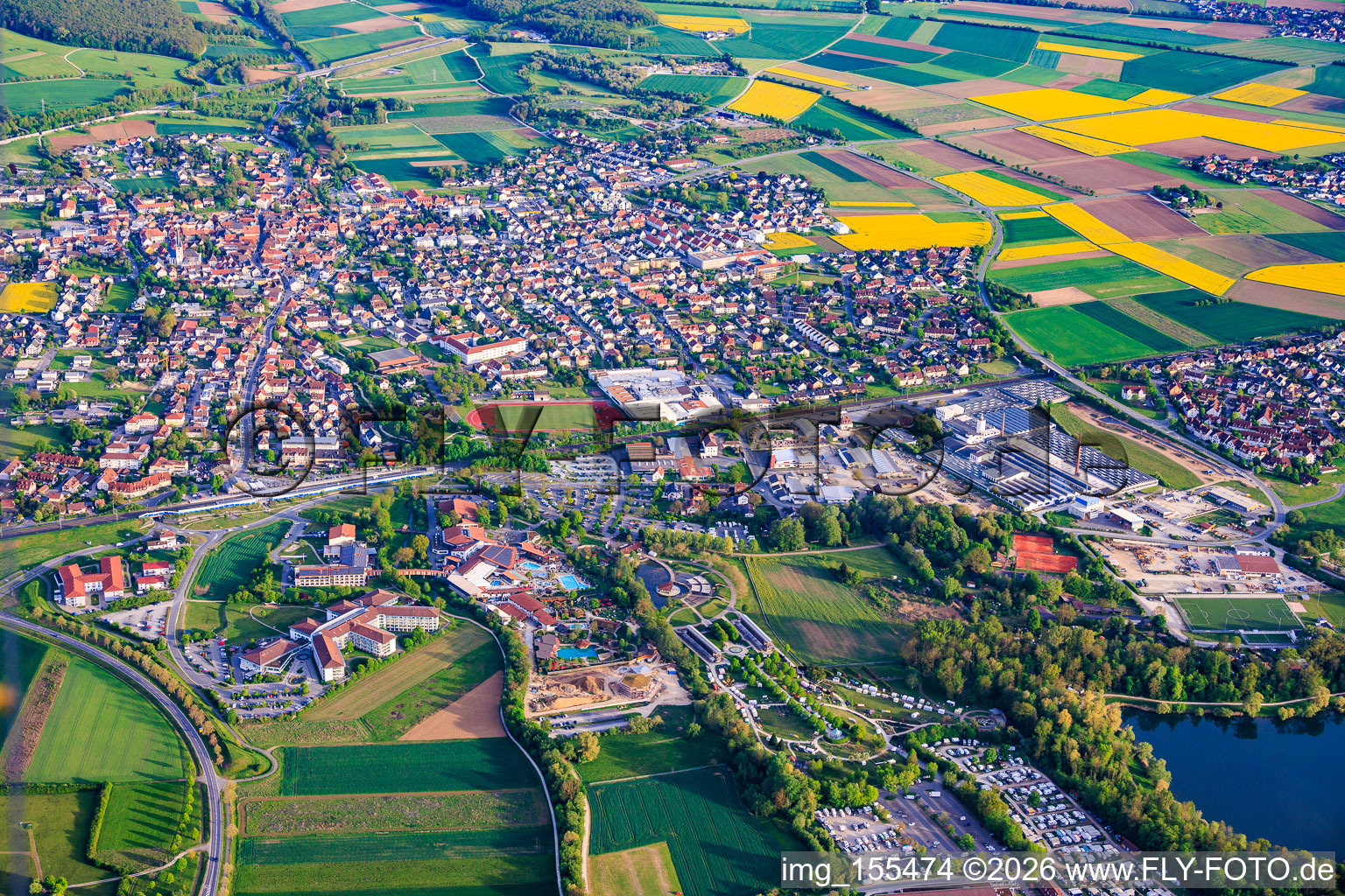 View of the spa town from the north with the Staffelstein-West industrial park and Goebel Porzellan GmbH, as well as the spa park with its lakeside stage, Obermain Therme and Schön Klinik Bad Staffelstein in Bad Staffelstein in the state Bavaria, Germany