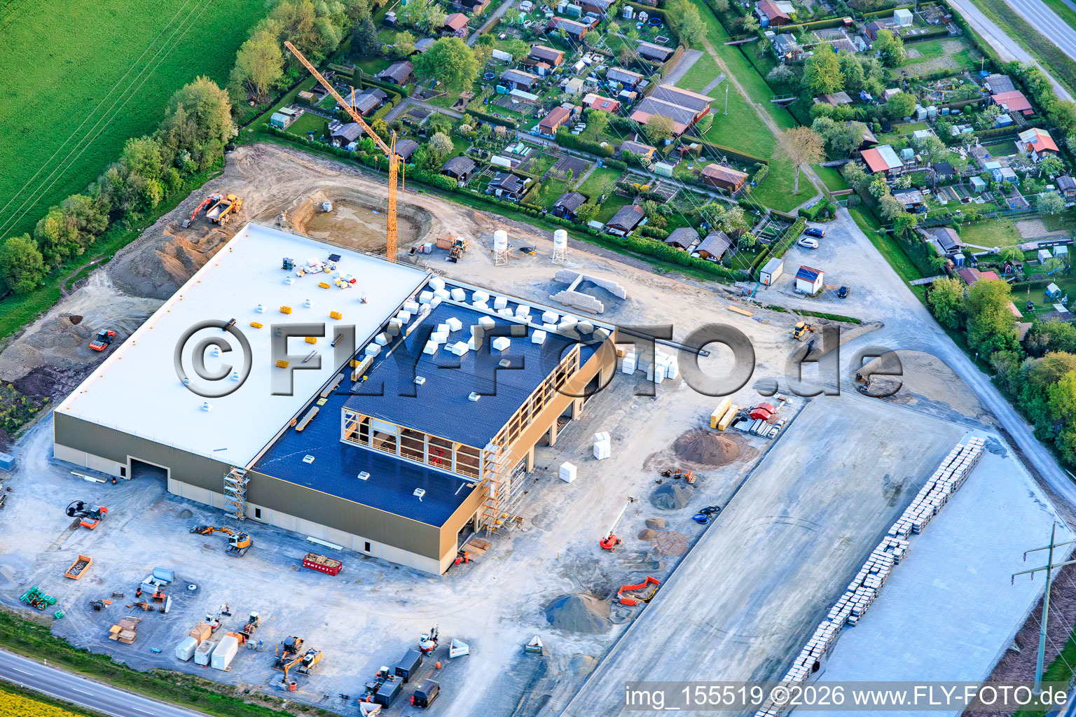 New construction site of the company Benkert Dachbegrünung GmbH & Co. KG between Prappacher Straße and the Godelstatt industrial park for a hall and office building at the Hassfurt allotment garden association. in the district Kleinaugsfeld in Haßfurt in the state Bavaria, Germany