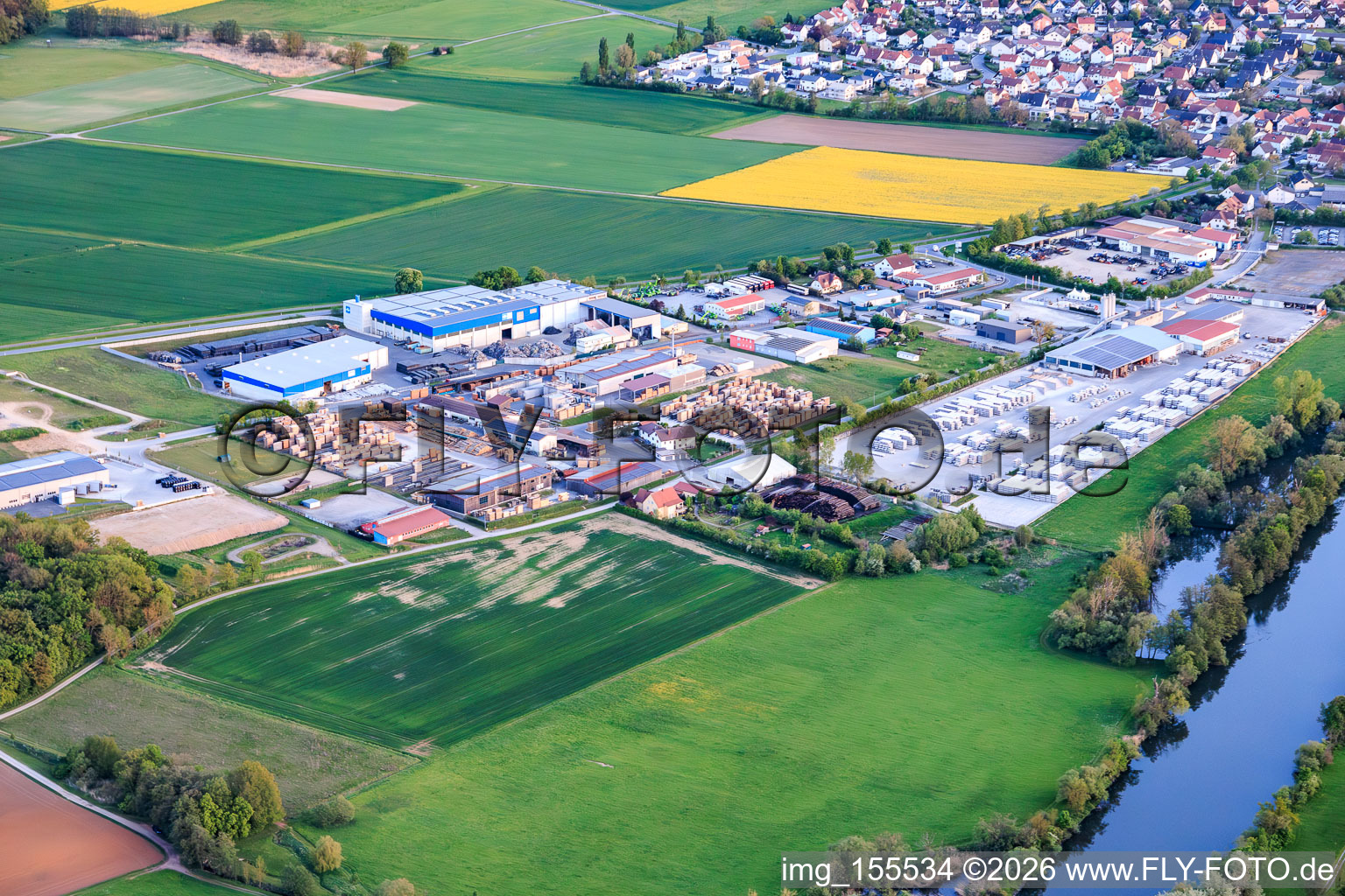 Industrial park on the banks of the Main River with Reitz GmbH sawmill and GODELMANN GmbH & Co. KG concrete plant. in Wonfurt in the state Bavaria, Germany