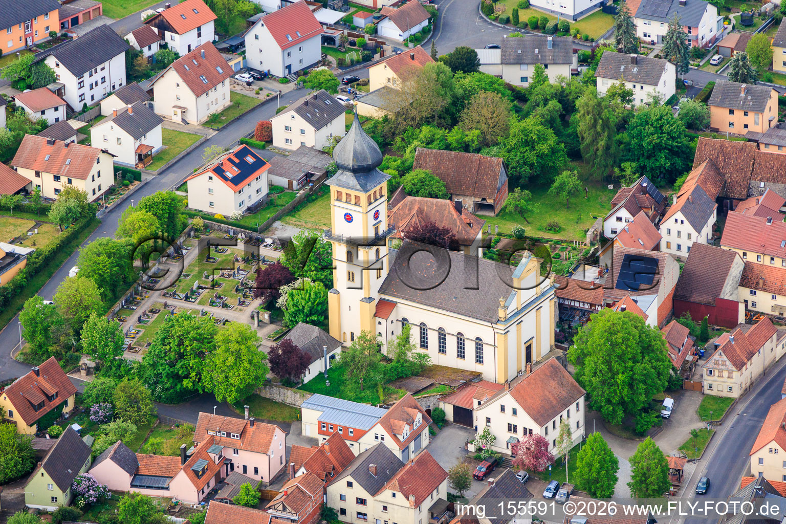 Cemetery and church square with St. Vitus in the district Langendorf in Elfershausen in the state Bavaria, Germany