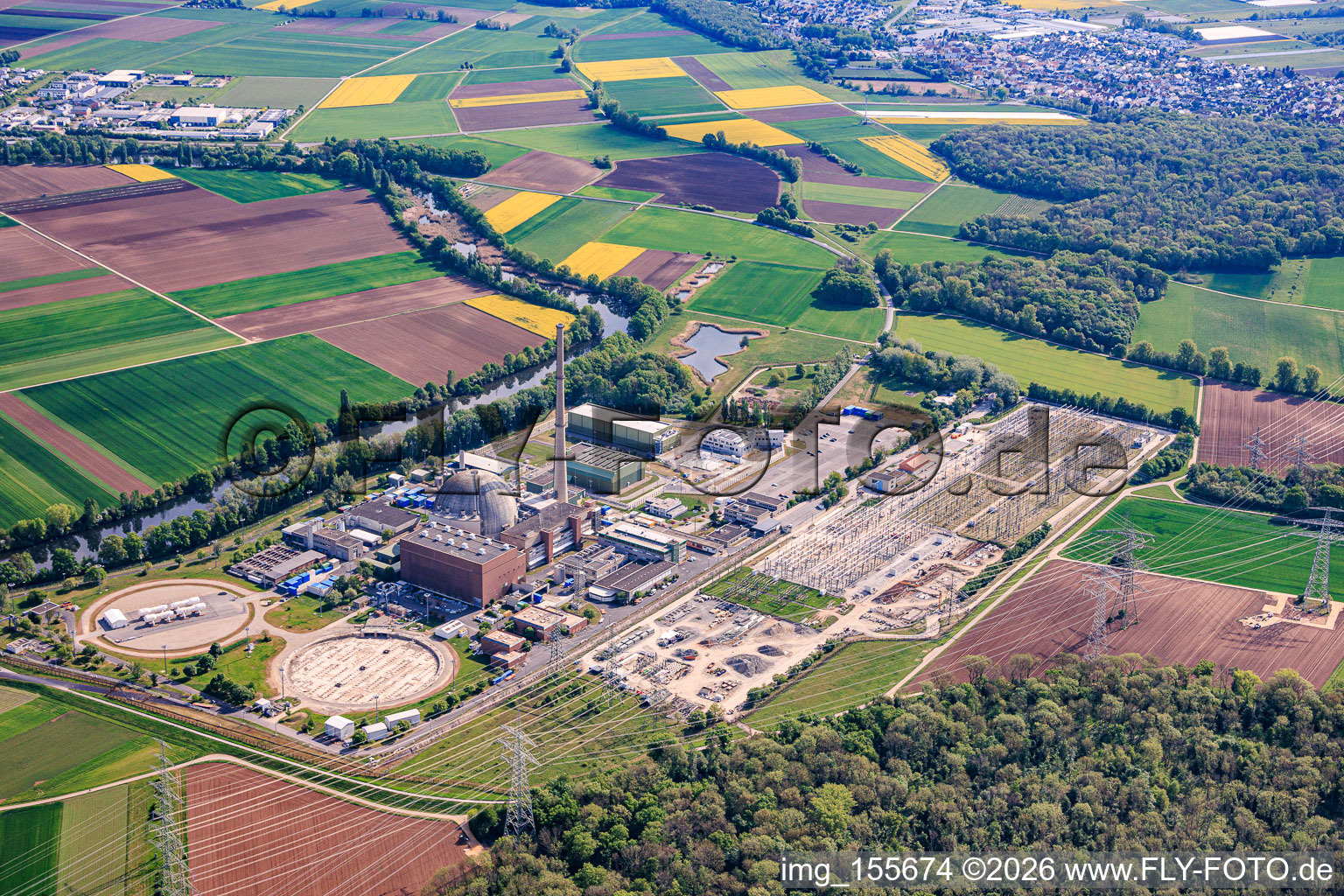 Decommissioned nuclear power plant Grafenrheinfeld of Preussenelektra GmbH on the banks of the Main River with Castor storage in the "gymnasium" and large substation in Grafenrheinfeld in the state Bavaria, Germany