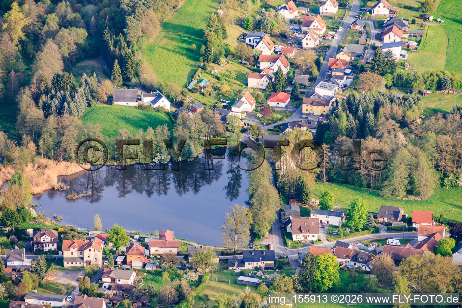Village view with heart-shaped mill pond from the north in the district Schierschnitz in Föritztal in the state Thuringia, Germany