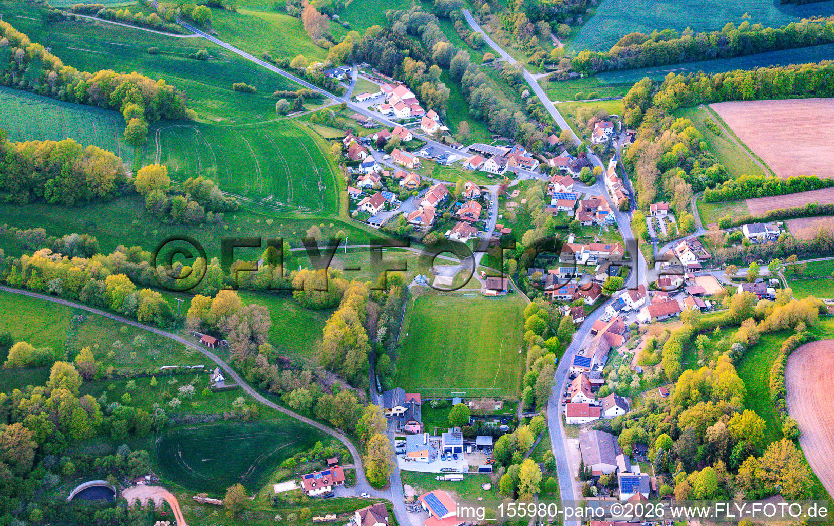 Village view from the southeast with the sports field of SC Lußberg-Rudendorf in the district Lußberg in Breitbrunn in the state Bavaria, Germany