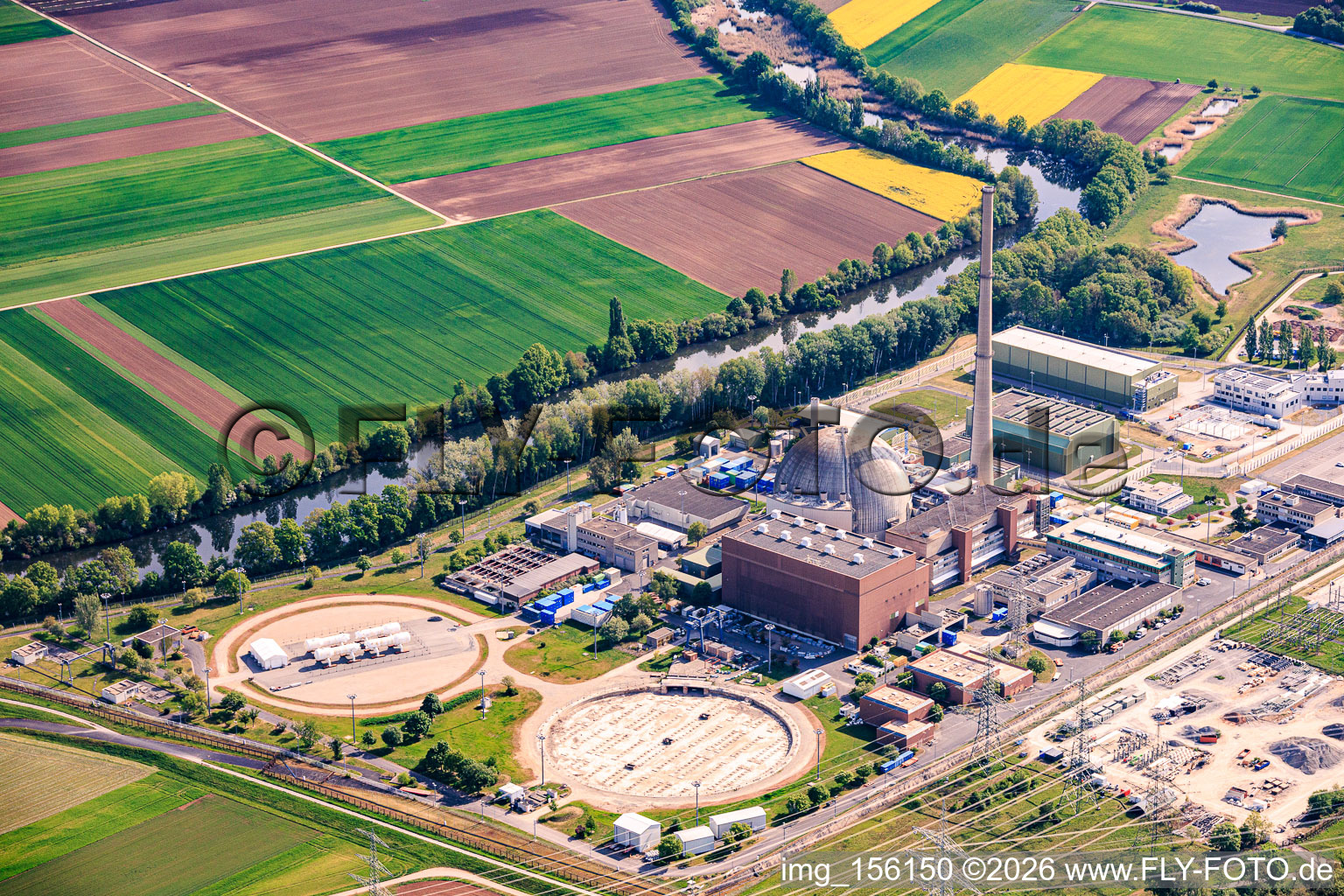 Former cooling towers Grafenrheinfeld at the decommissioned nuclear power plant Grafenrheinfeld of Preussenelektra GmbH on the banks of the Main River with Castor storage in the "gymnasium" in Grafenrheinfeld in the state Bavaria, Germany