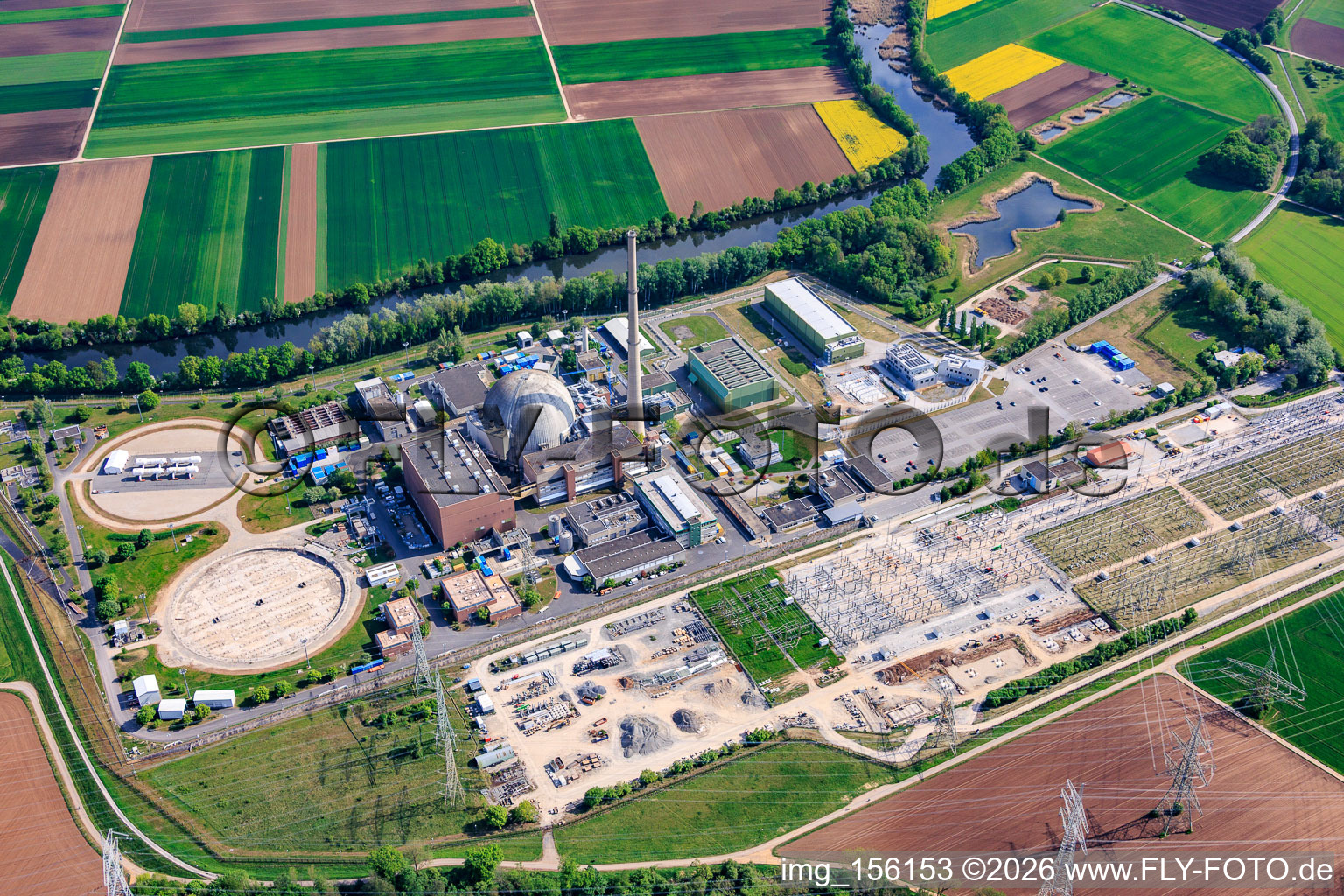 Decommissioned nuclear power plant Grafenrheinfeld of Preussenelektra GmbH on the banks of the Main River with Castor storage in the "gymnasium" and large substation in Grafenrheinfeld in the state Bavaria, Germany