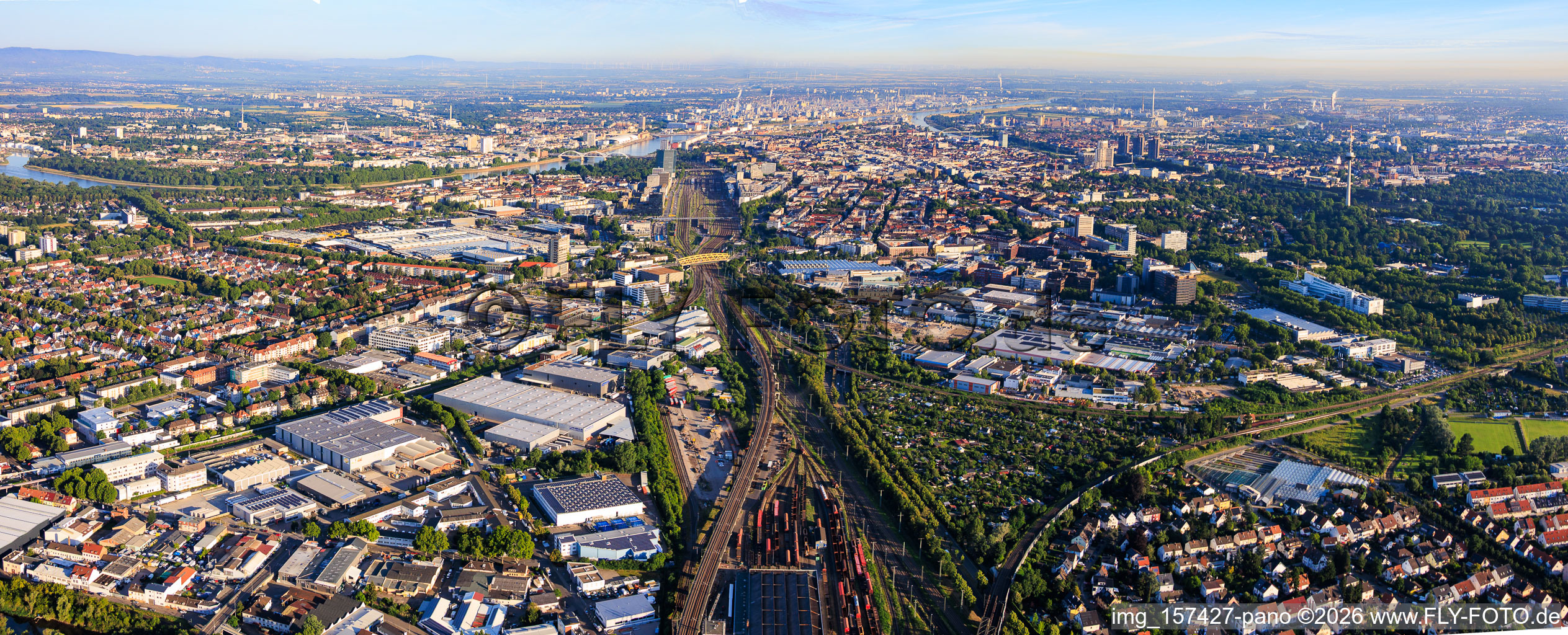 View of the district from the east, on both sides of the railway tracks up to the Rhine, with Rhenus Automotive and John Deere GmbH & Co KG in the foreground, Fahrlach industrial park. in the district Almenhof in Mannheim in the state Baden-Wuerttemberg, Germany