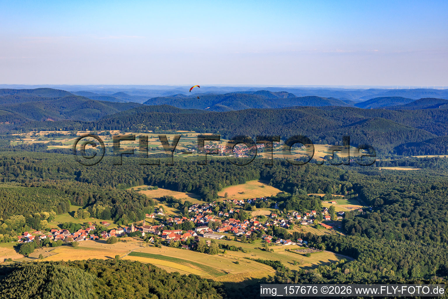 Village view from the east with paraglider in Climbach in the state Bas-Rhin, France