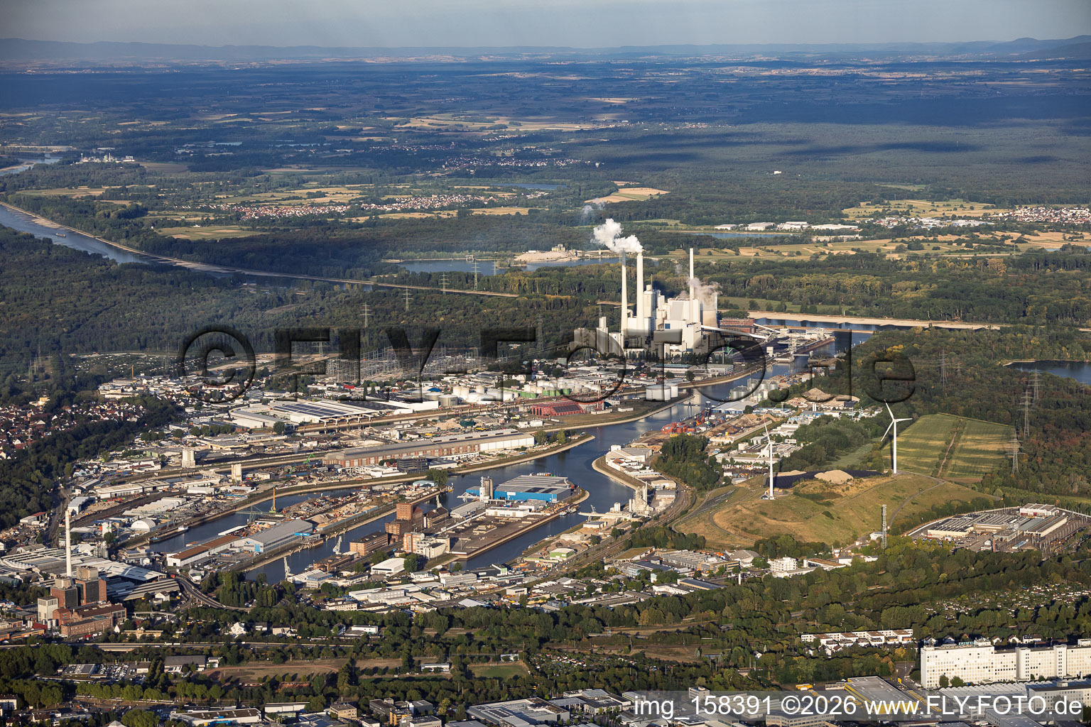 Rhine ports Karlsruhe and West Landfill (Energy Hill) with two wind turbines in front of the steam power plant Karlsruhe, viewed from the east in the district Mühlburg in Karlsruhe in the state Baden-Wuerttemberg, Germany