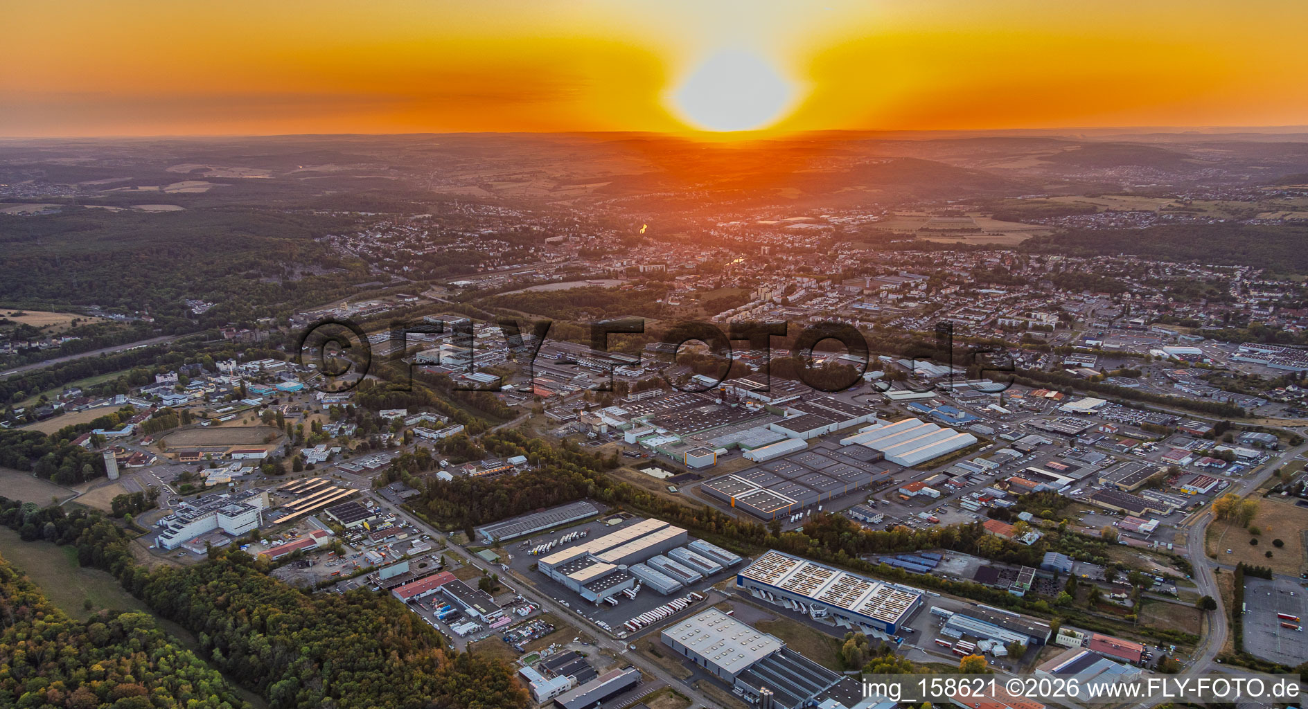 Sunset over the industrial area in the district Zone Industrielle du Grand Bois Fayencerie in Saargemünd in the state Moselle, France