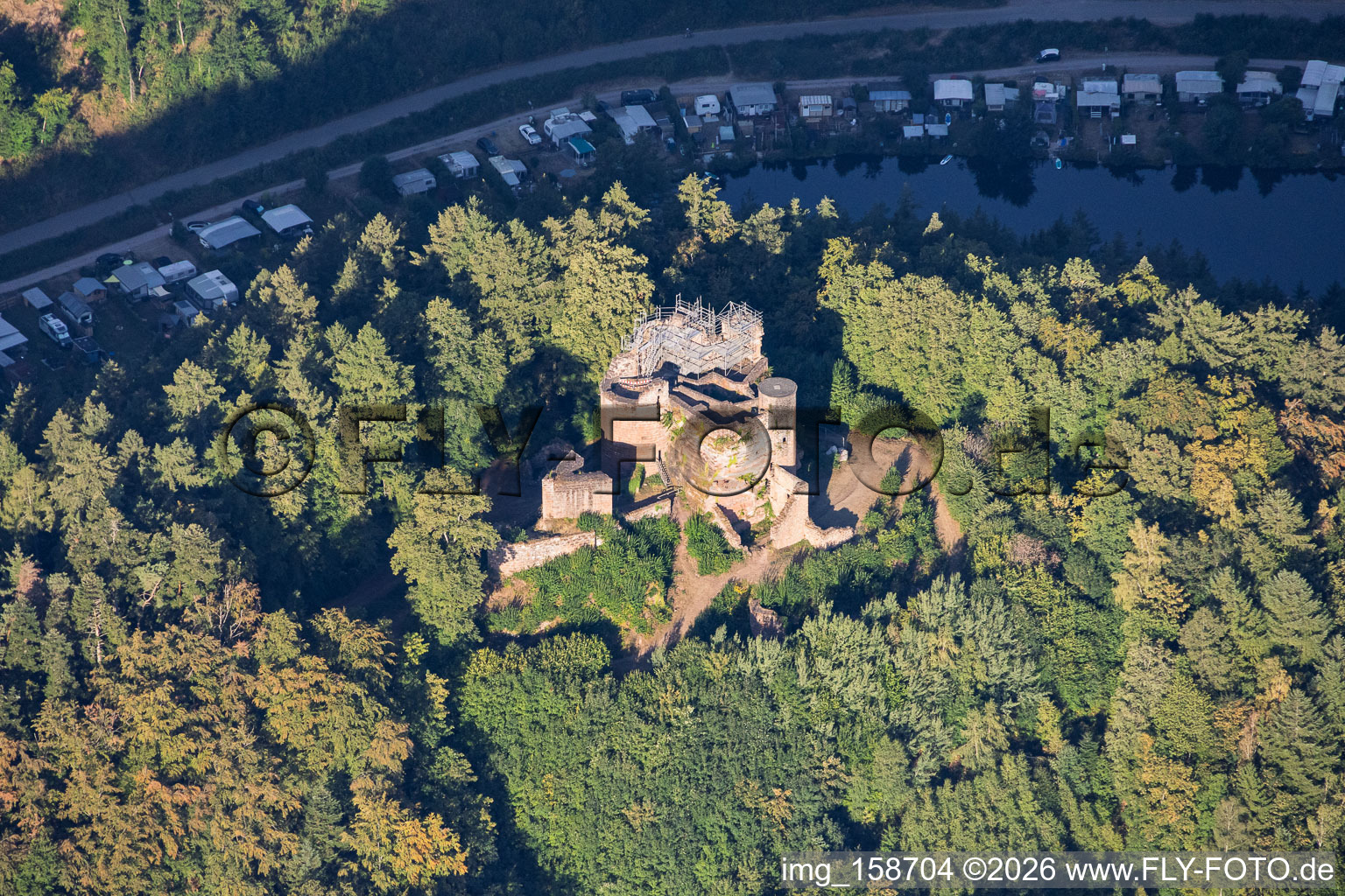 Neudahn castle ruins (scaffolded for renovation) overlooking the Neudahn Pond in Dahn in the state Rhineland-Palatinate, Germany