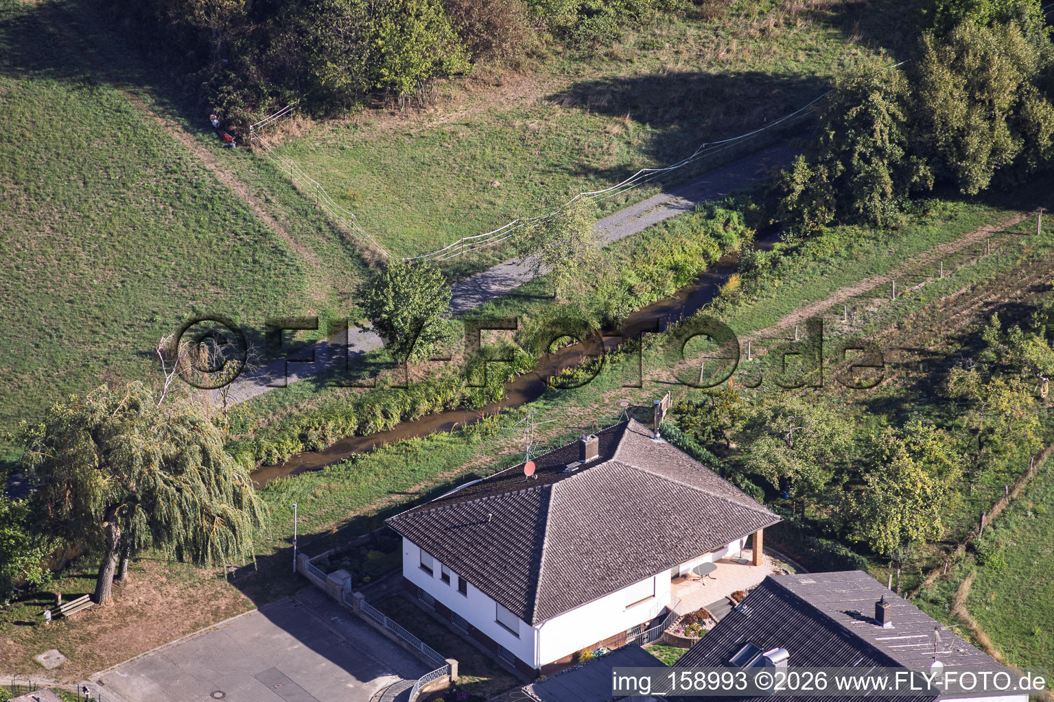 Landrat-Pfeifer-Straße and the Richerbach stream in the district Sickenhofen in Babenhausen in the state Hesse, Germany