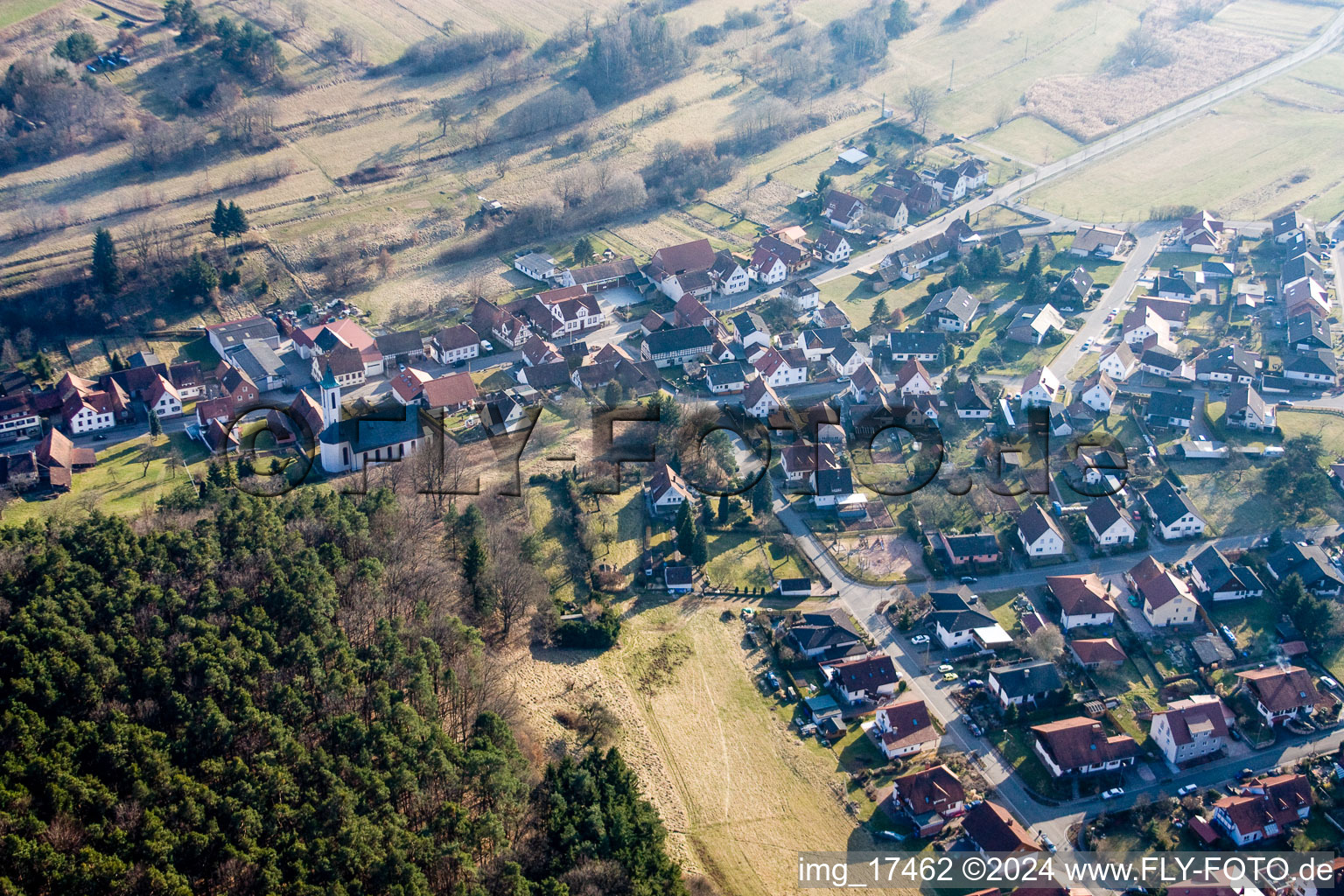 Aerial view of Village - view on the edge of agricultural fields and farmland in Schindhard in the state Rhineland-Palatinate, Germany