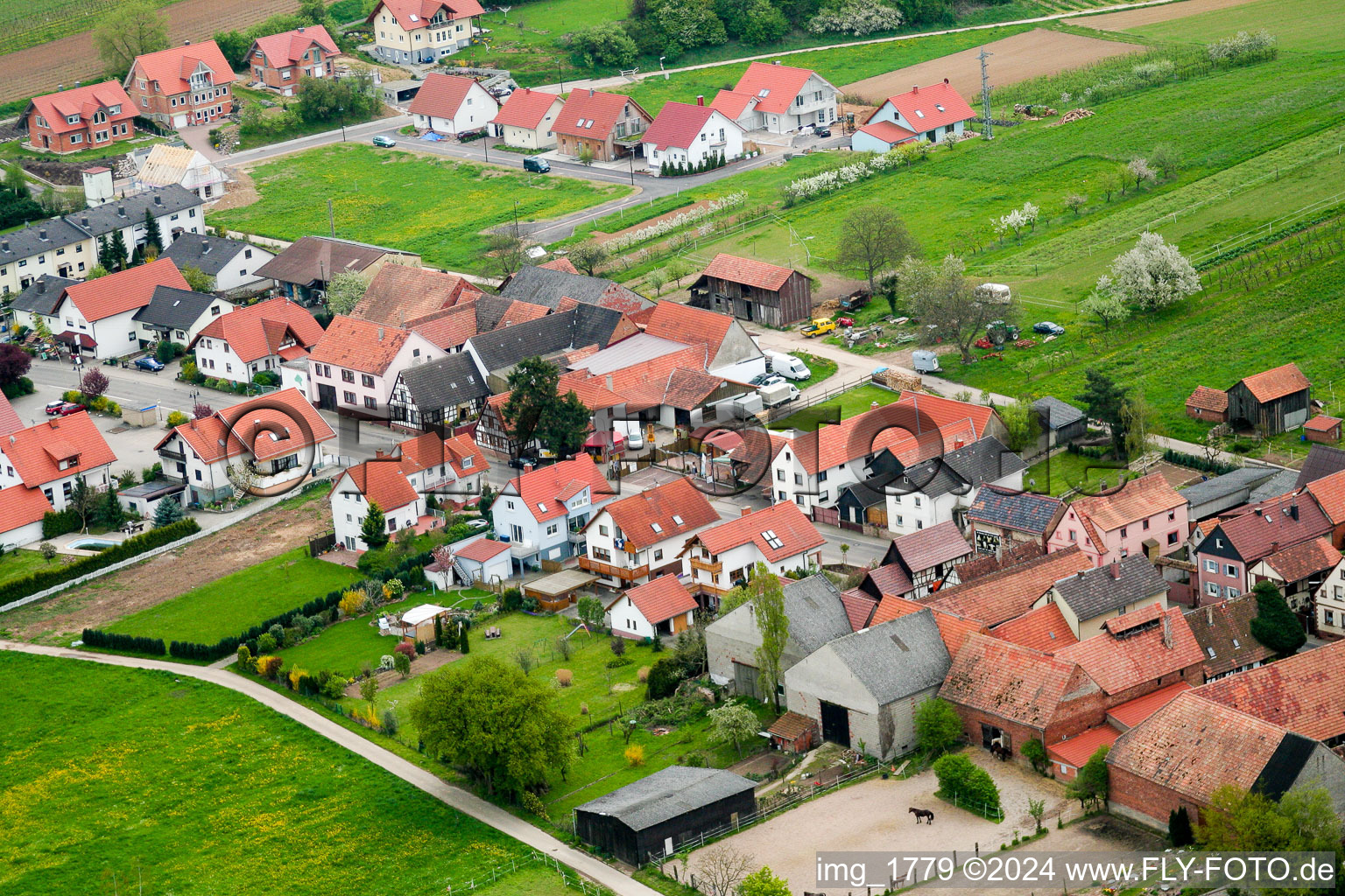 Aerial view of Village - view on the edge of agricultural fields and farmland in Hergersweiler in the state Rhineland-Palatinate