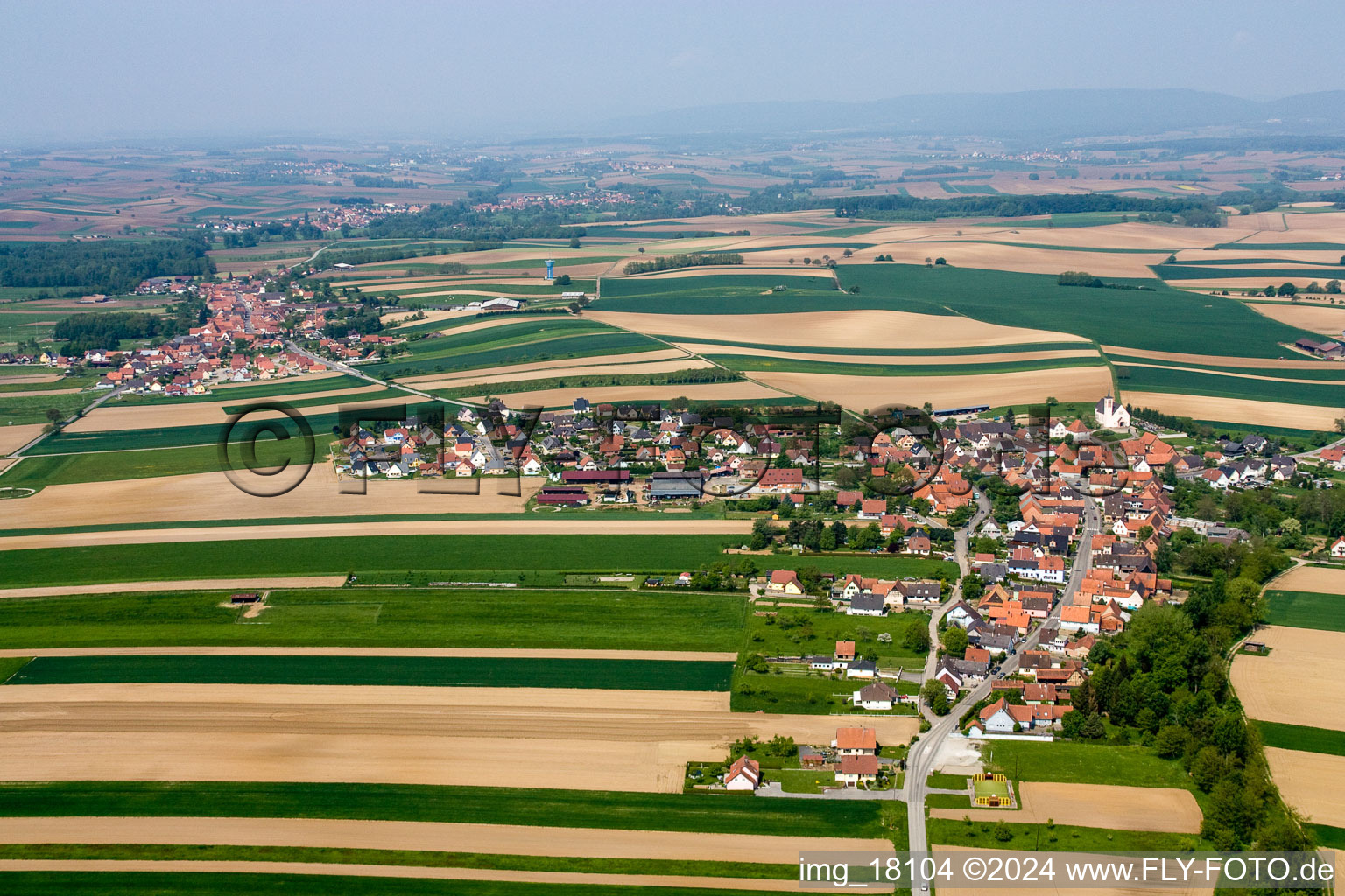 Village - view on the edge of agricultural fields and farmland in Stundwiller in Grand Est, France