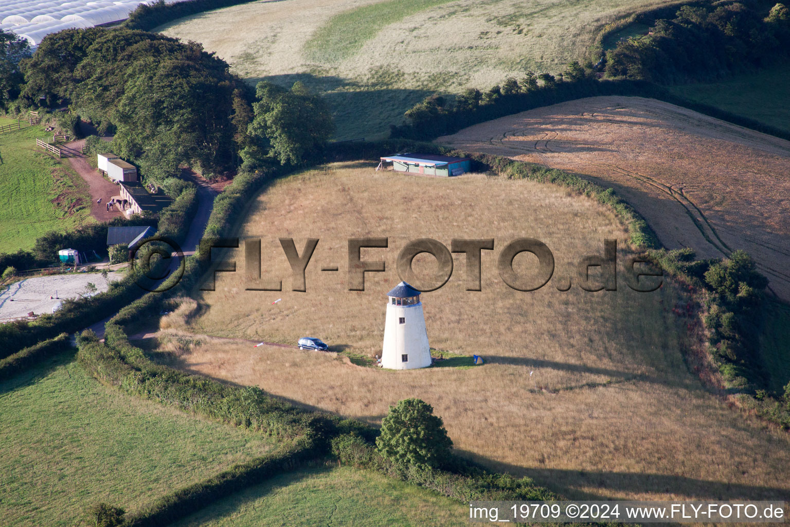 Historic windmill on the edge of cultivated fields in Whilborough in England, United Kingdom