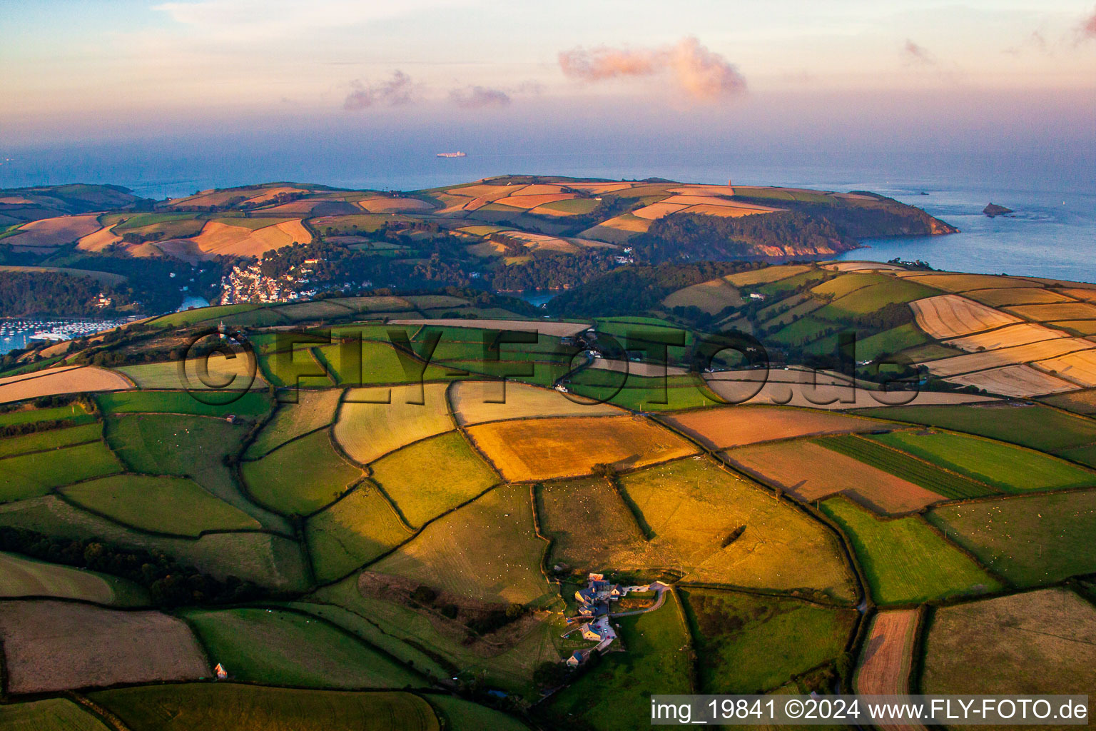 Fields before marine coastal area of Dartmouth in England, United Kingdom