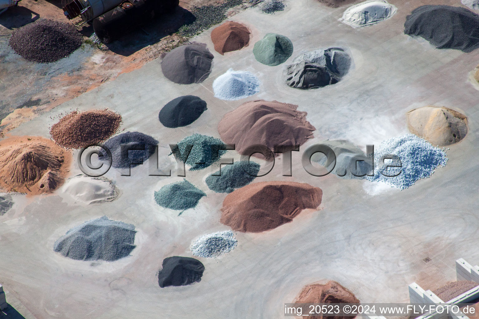 Piles of coloured gravel in the depot of Badische Terrazzo Handelsgesellschaft mbH in the district Neudorf in Graben-Neudorf in the state Baden-Wurttemberg