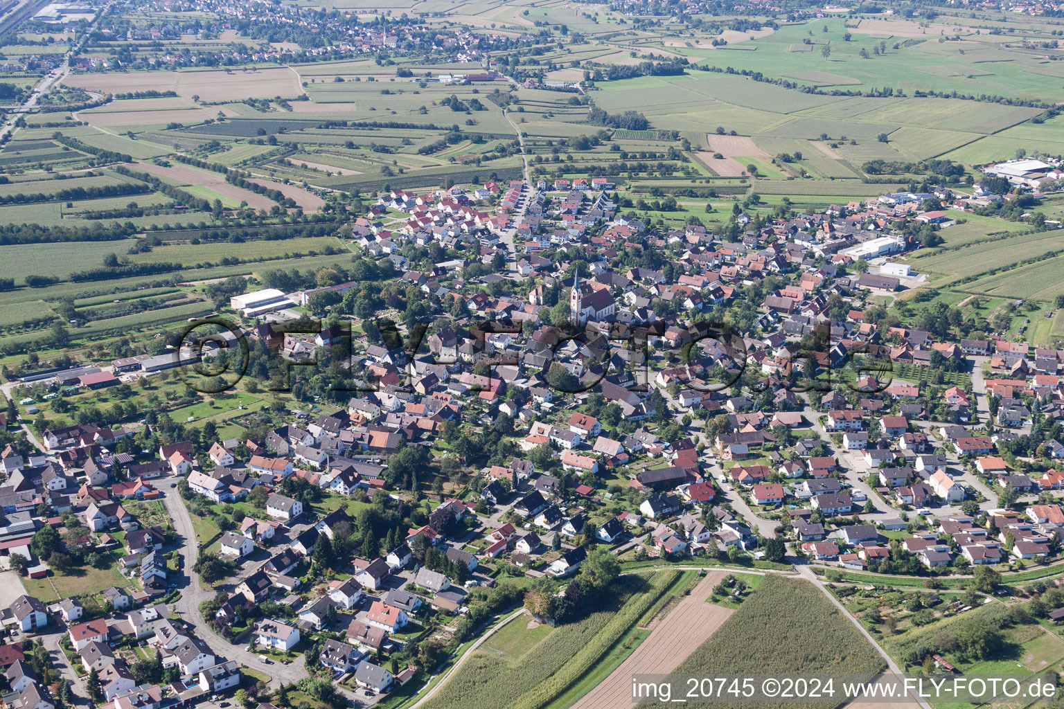 Village - view on the edge of agricultural fields and farmland in Windschlaeg in the state Baden-Wurttemberg, Germany