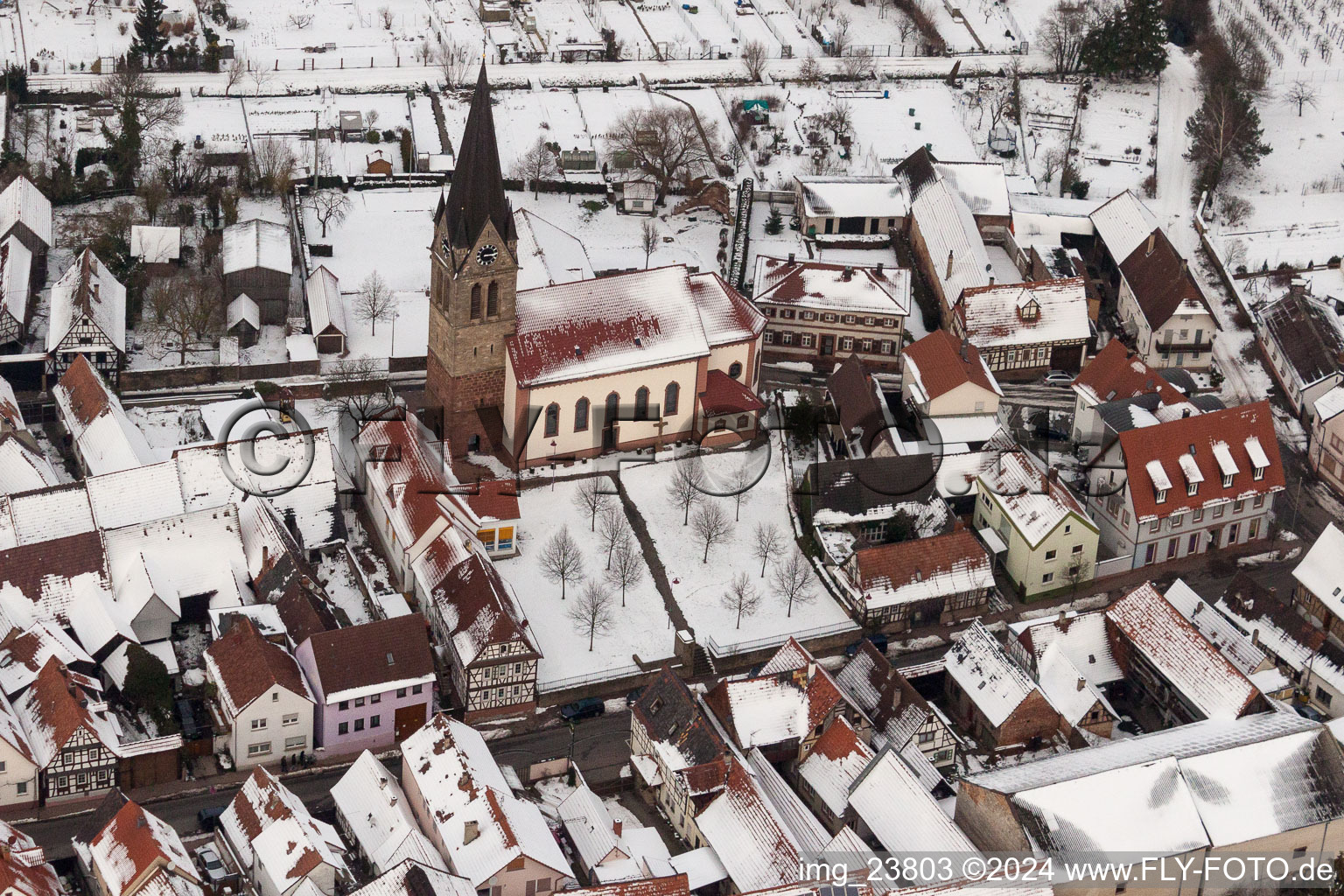 Aerial view of Wintry snowy Catholic Church building in the village of in Steinweiler in the state Rhineland-Palatinate, Germany