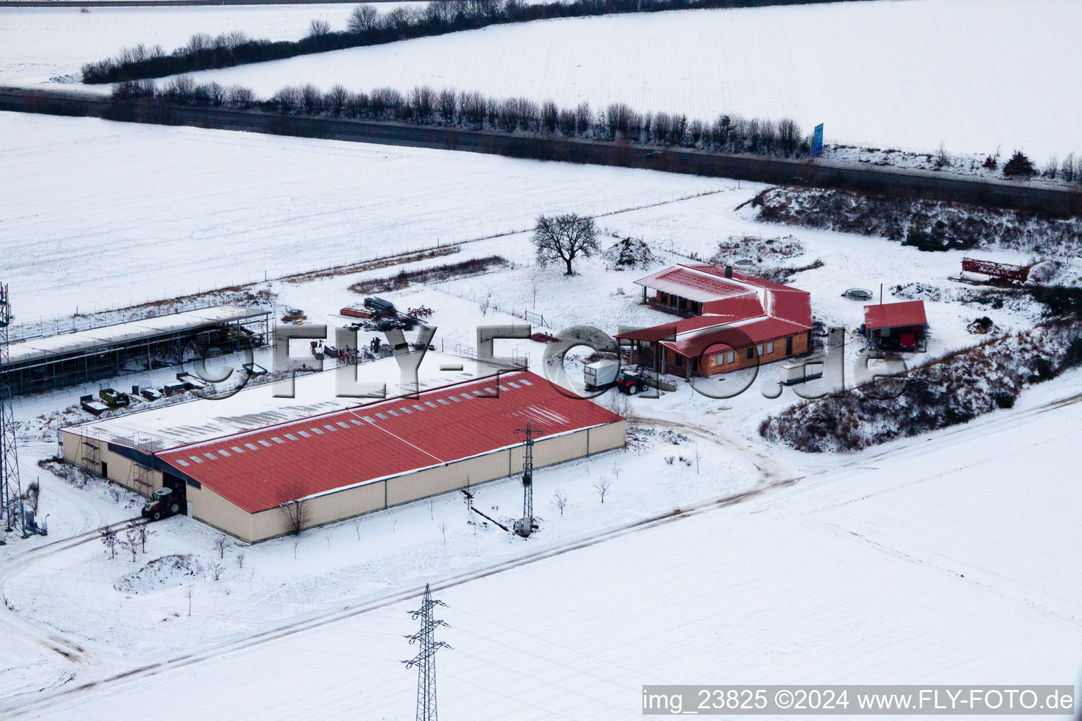 Aerial view of Chicken farm egg farm in winter with snow in Erlenbach bei Kandel in the state Rhineland-Palatinate, Germany