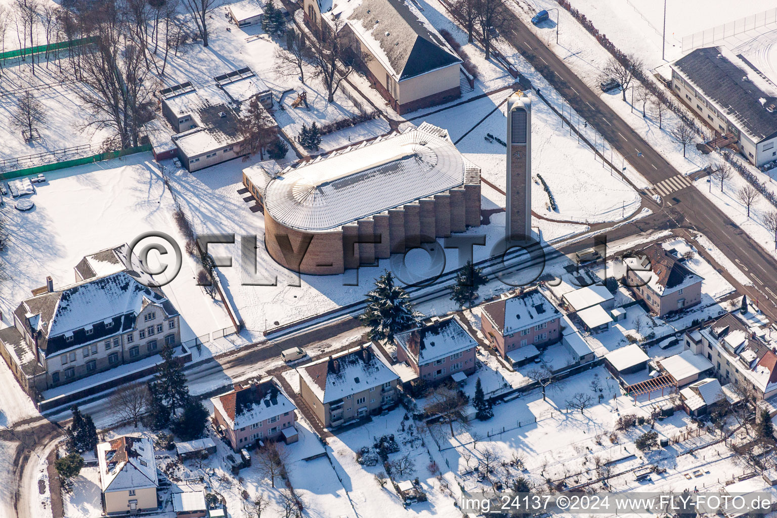 Wintry snowy Church tower and tower roof at the church building of St. Konrad in the district Nordweststadt in Karlsruhe in the state Baden-Wurttemberg, Germany