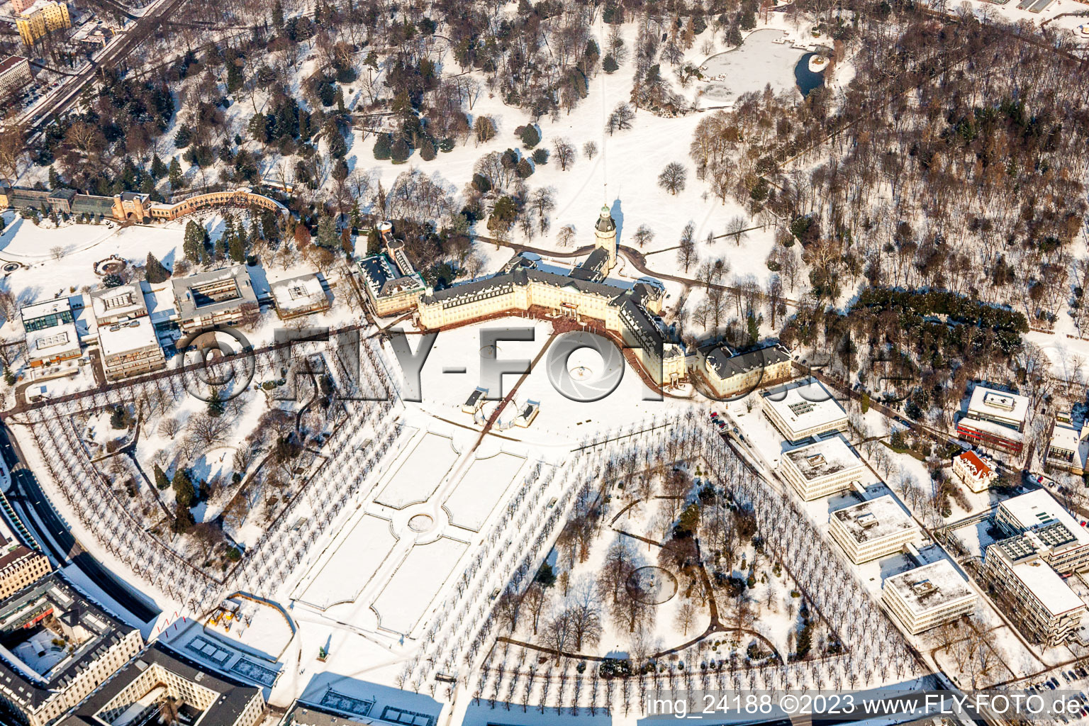 Wintry snowy Building complex in the park of the castle Schloss Karlsruhe in Karlsruhe in the state Baden-Wurttemberg, Germany seen from above