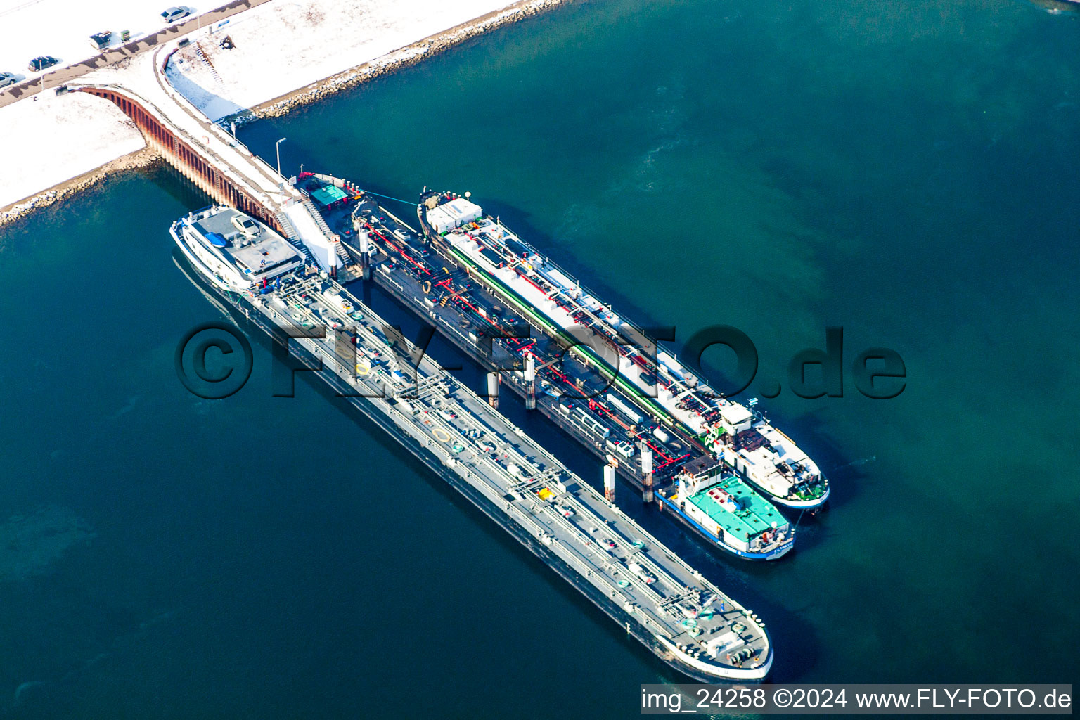 Aerial view of Wintry snowy Wharves and piers with ship loading terminals in the oil harbor in the district Knielingen in Karlsruhe in the state Baden-Wurttemberg, Germany