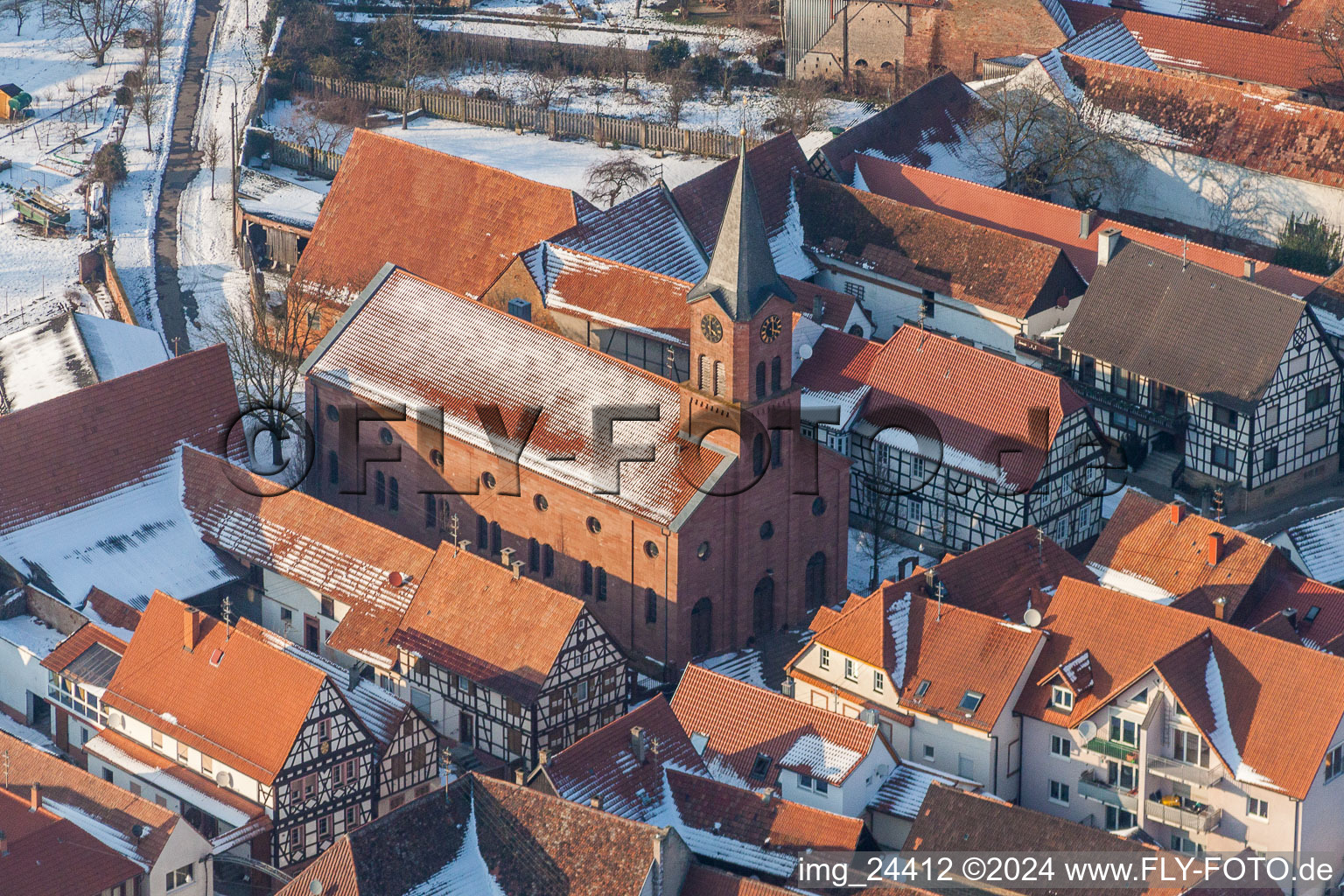 Aerial view of Wintry snowy Evangelic Church building in the village of in Steinweiler in the state Rhineland-Palatinate, Germany