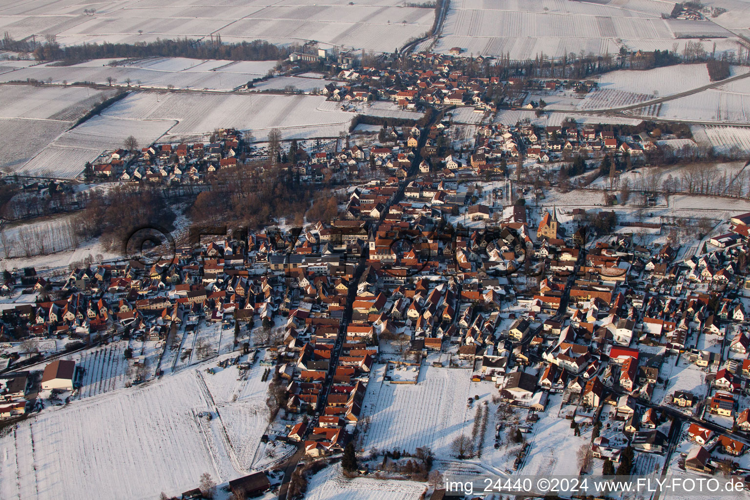 Wintry snowy Town View of the streets and houses of the residential areas in the district Ingenheim in Billigheim-Ingenheim in the state Rhineland-Palatinate from above