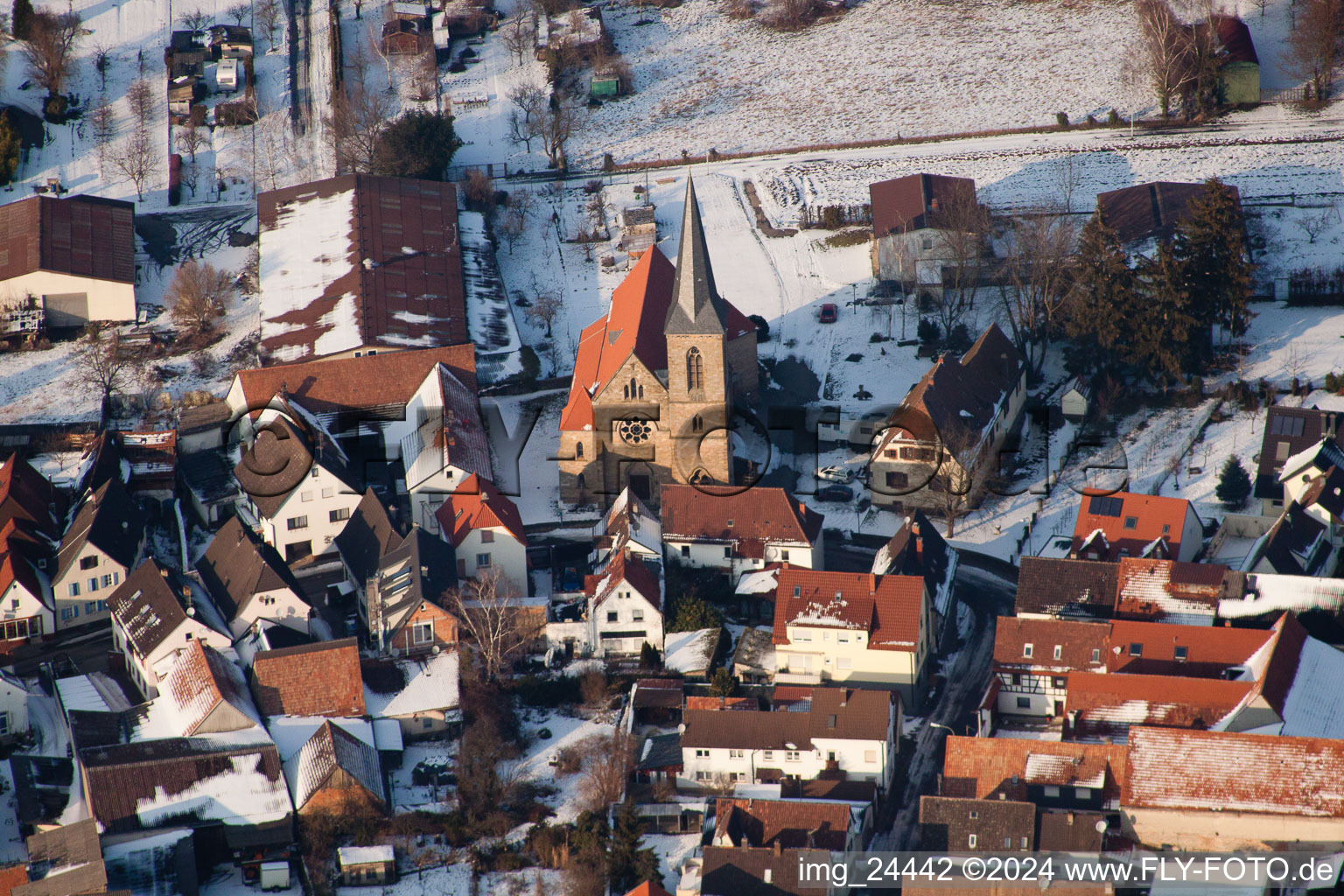 Wintry snowy Town View of the streets and houses of the residential areas in the district Ingenheim in Billigheim-Ingenheim in the state Rhineland-Palatinate out of the air