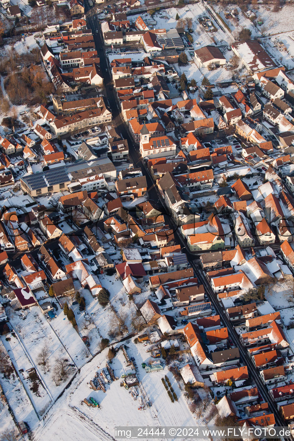 Wintry snowy Town View of the streets and houses of the residential areas in the district Ingenheim in Billigheim-Ingenheim in the state Rhineland-Palatinate seen from above