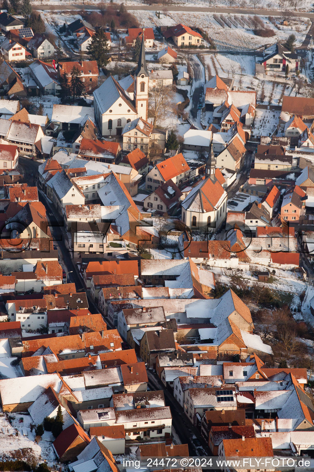 Winter snow covered village view in Göcklingen in the state Rhineland-Palatinate, Germany seen from above