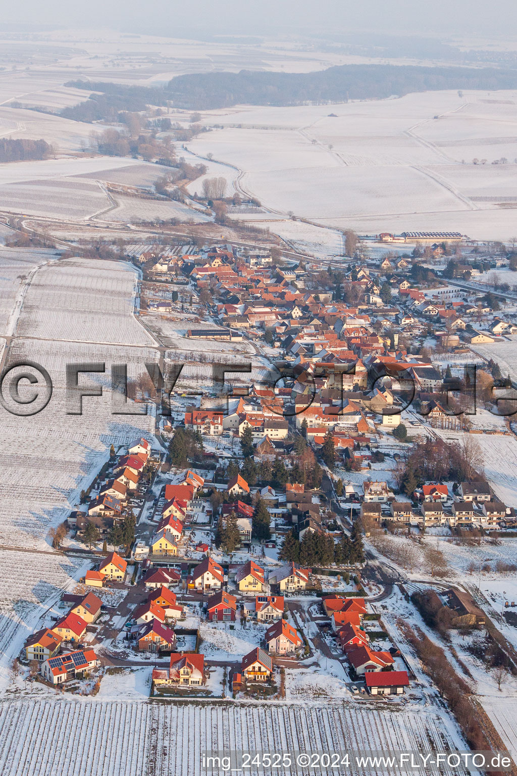 Wintry snowy Village - view on the edge of agricultural fields and farmland in Niederhorbach in the state Rhineland-Palatinate, Germany