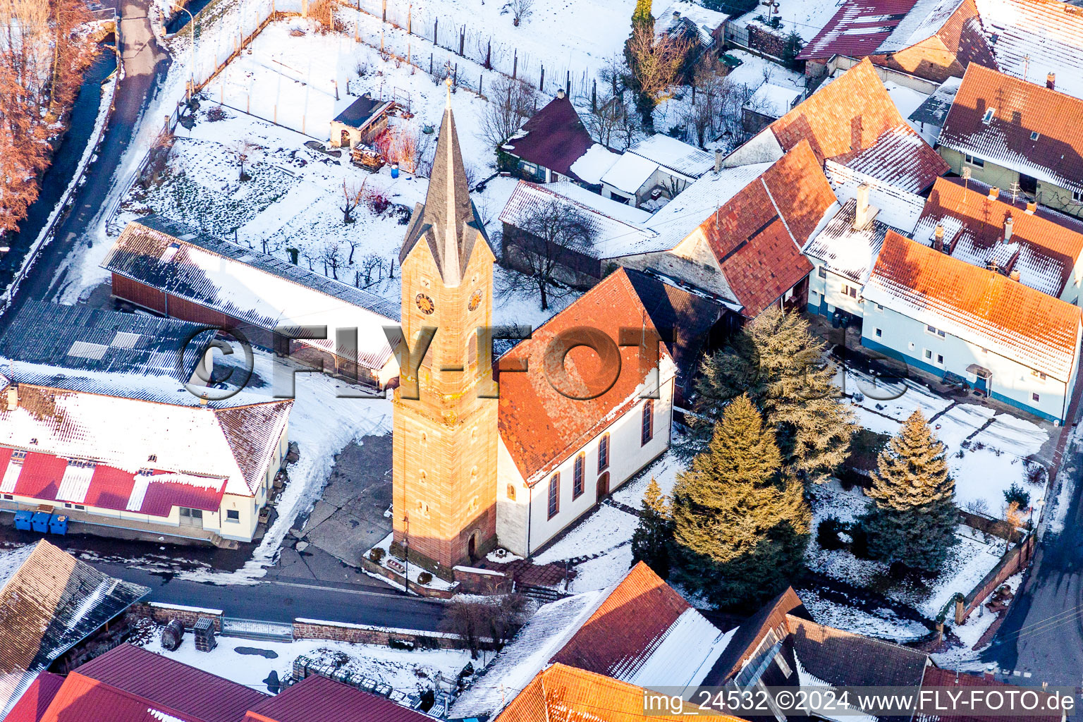 Aerial view of Wintry snowy Church building in the village of in Kapellen-Drusweiler in the state Rhineland-Palatinate, Germany