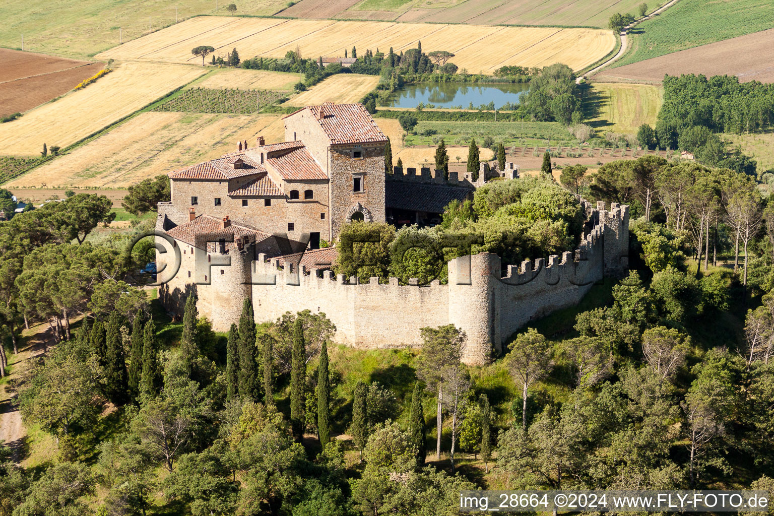 Aerial view of Castle of the fortress Castello di Montegualandro on lake Trasemino in Montecchio in Umbria, Italy