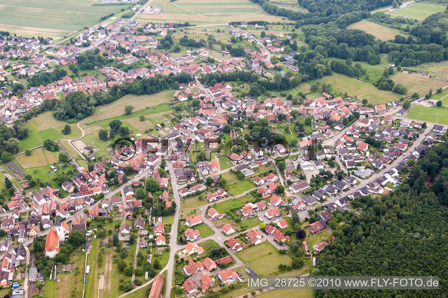 Aerial view of Village - view on the edge of agricultural fields and farmland in Scheibenhardt in the state Rhineland-Palatinate, Germany