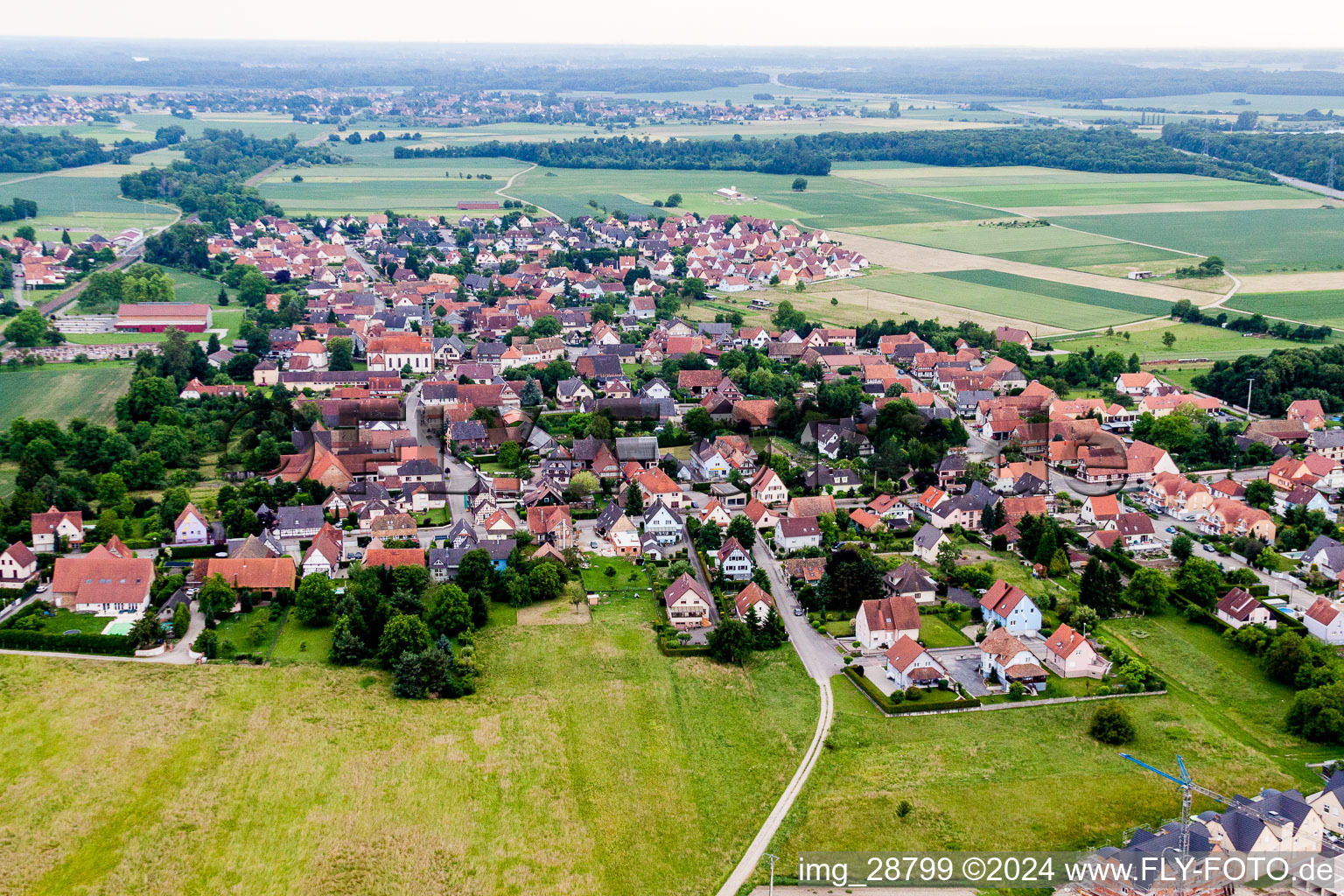 Village - view on the edge of agricultural fields and farmland in Rountzenheim in Grand Est, France