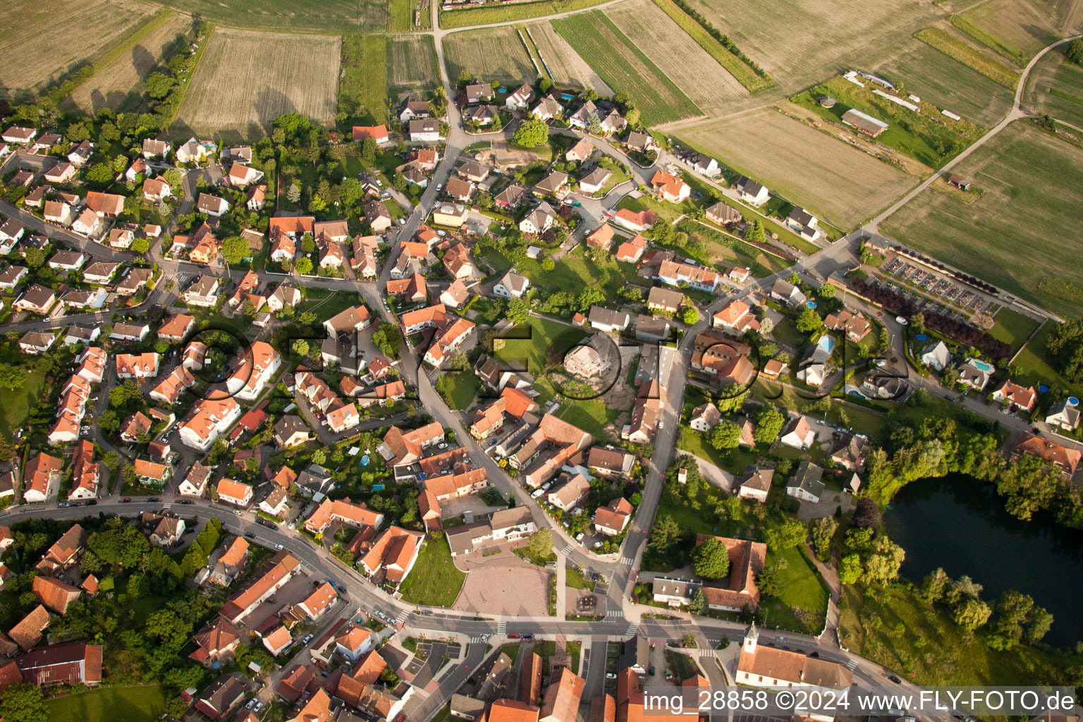 Village - view on the edge of agricultural fields and farmland in Gambsheim in Grand Est, France