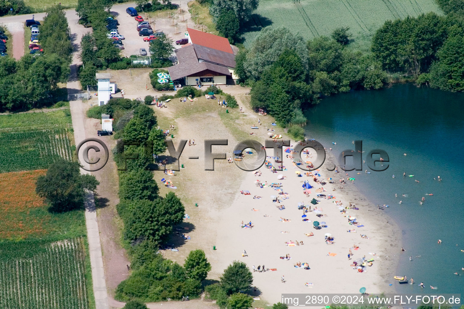 Bathers on the beach and the shore areas of the lake Johanneswiese in Jockgrim in Jockgrim in the state Rhineland-Palatinate