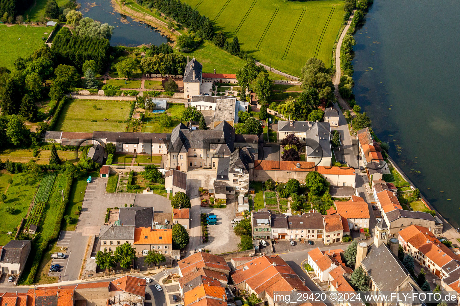 Aerial view of Building complex in the park of the castle at shore of the Mosel river in Rettel in Grand Est, France