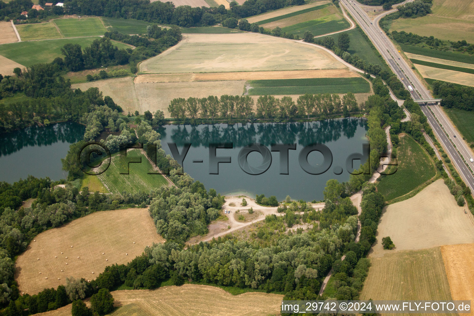 Quarry lake on the B9 in Rheinzabern in the state Rhineland-Palatinate, Germany