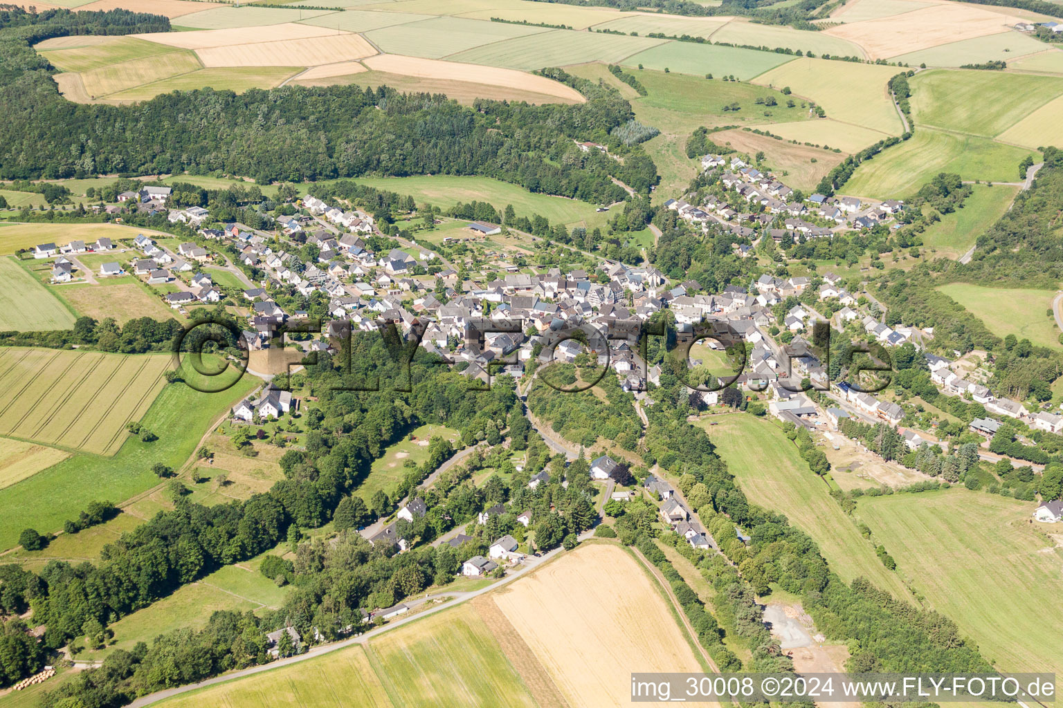 Village - view on the edge of agricultural fields and farmland in Mengerschied in the state Rhineland-Palatinate, Germany
