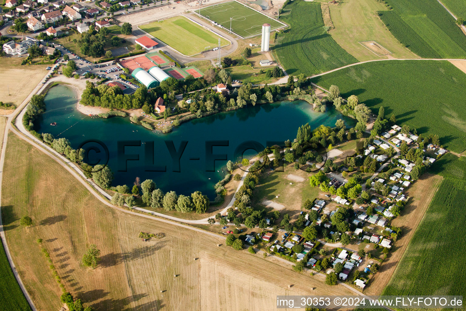 Camping with caravans and tents at a lake with beach in Gambsheim in Grand Est, France