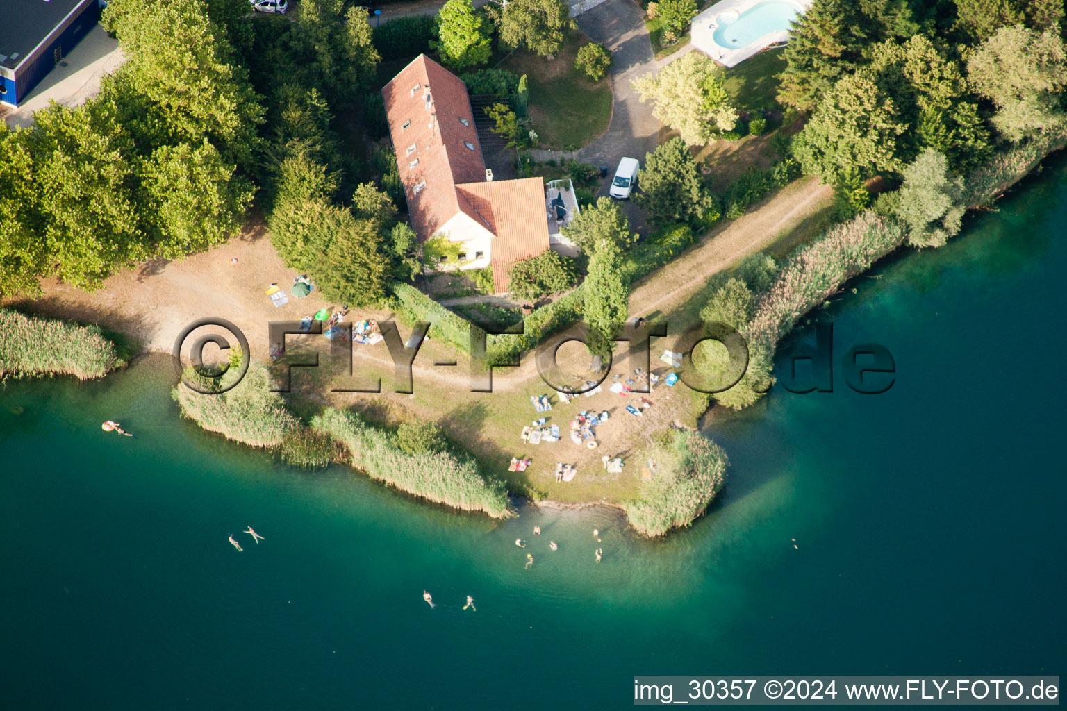Aerial view of Camping with caravans and tents at a lake with beach in Gambsheim in Grand Est, France