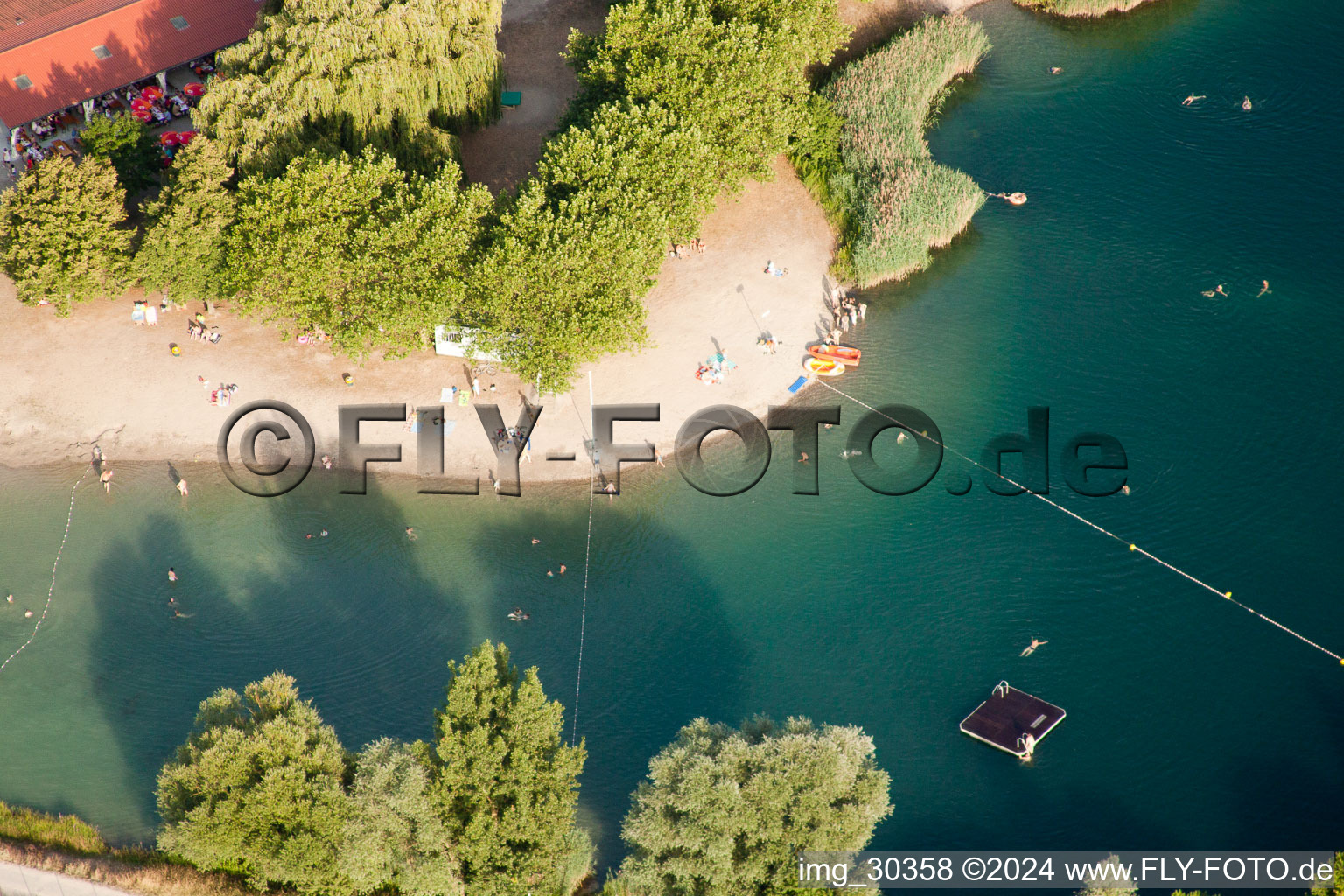 Aerial photograpy of Camping with caravans and tents at a lake with beach in Gambsheim in Grand Est, France