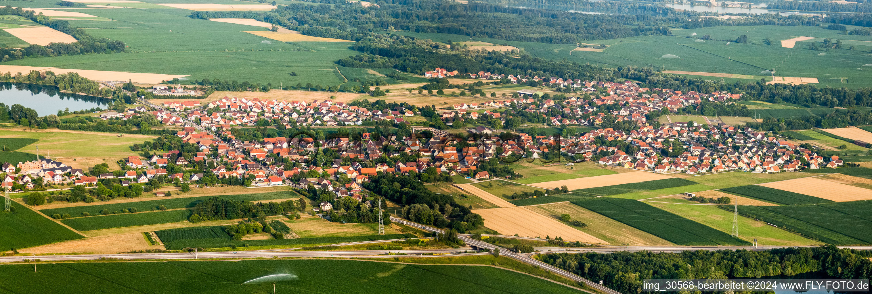 Panoramic perspective Village - view on the edge of agricultural fields and farmland in Rountzenheim in Grand Est, France