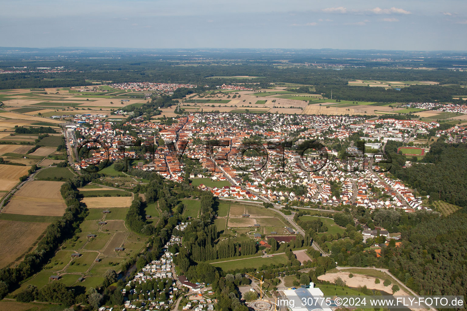Village - view on the edge of agricultural fields and farmland in Ruelzheim in the state Rhineland-Palatinate, Germany